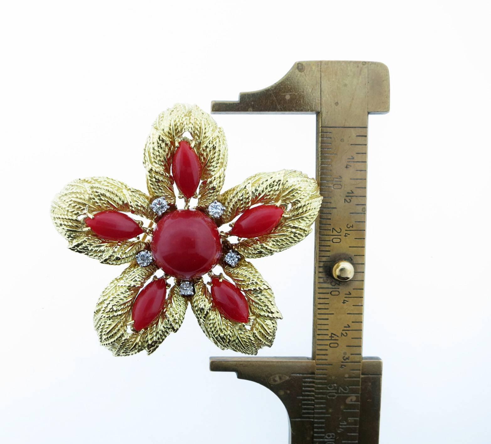 Well constructed in 18kt. yellow gold the floral design brooch  can be worn as a brooch or a pendant. The center is set with a 12 mm. richly colored natural coral bead surrounded by five well matched marquise shape corals inter-spaced with five