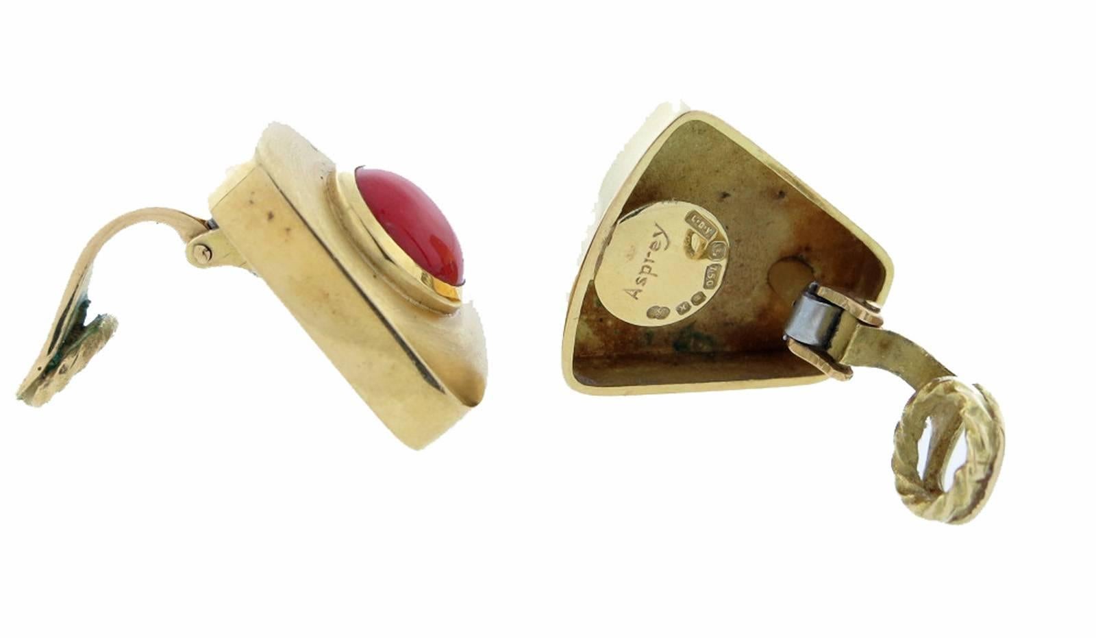 18kt. yellow gold matt finish earrings made by Asprey. The center is bezel set with a richly colored domed coral  each measuring approx 9.7 mm. Clip back , posts can be added. Hallmarked and signed. 