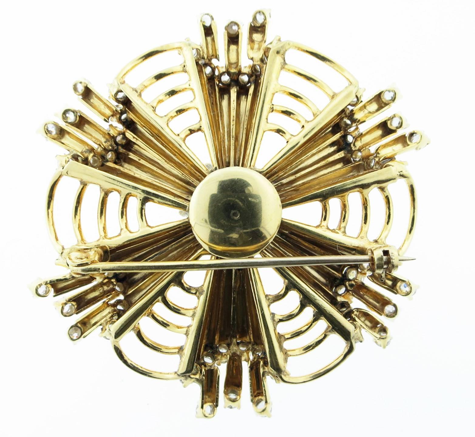 14kt. yellow gold retro brooch in a fluted web design set with 60 round European cut diamonds totaling approx .75cts. The brooch measures 2 1/2 inches and weighs 26.4 gr. Cosmic ... Circa 1945.
