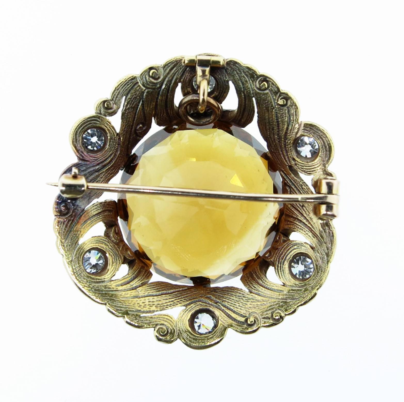 Handmade and hand engraved front and back 14kt yellow gold  citrine and diamond brooch pendant. The center is prong set  with a faceted natural golden citrine weighing approx  28cts. The brooch measures approx 1 1/2 inches and the open work frame is