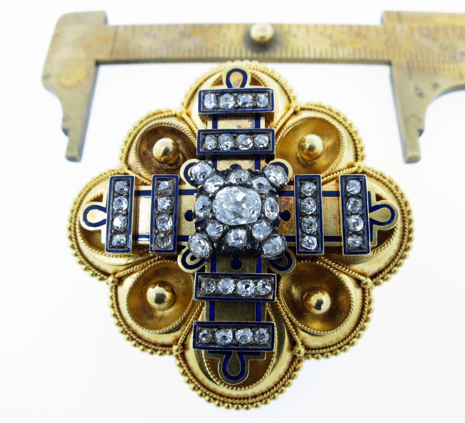 Near perfect condition Victorian brooch pendant locket measuring two inches. The center is set with a mine cut diamond weighing approx .40cts. The mount is bead set with 54 old rose cut diamonds with cobalt enamel detail Circa 1880.