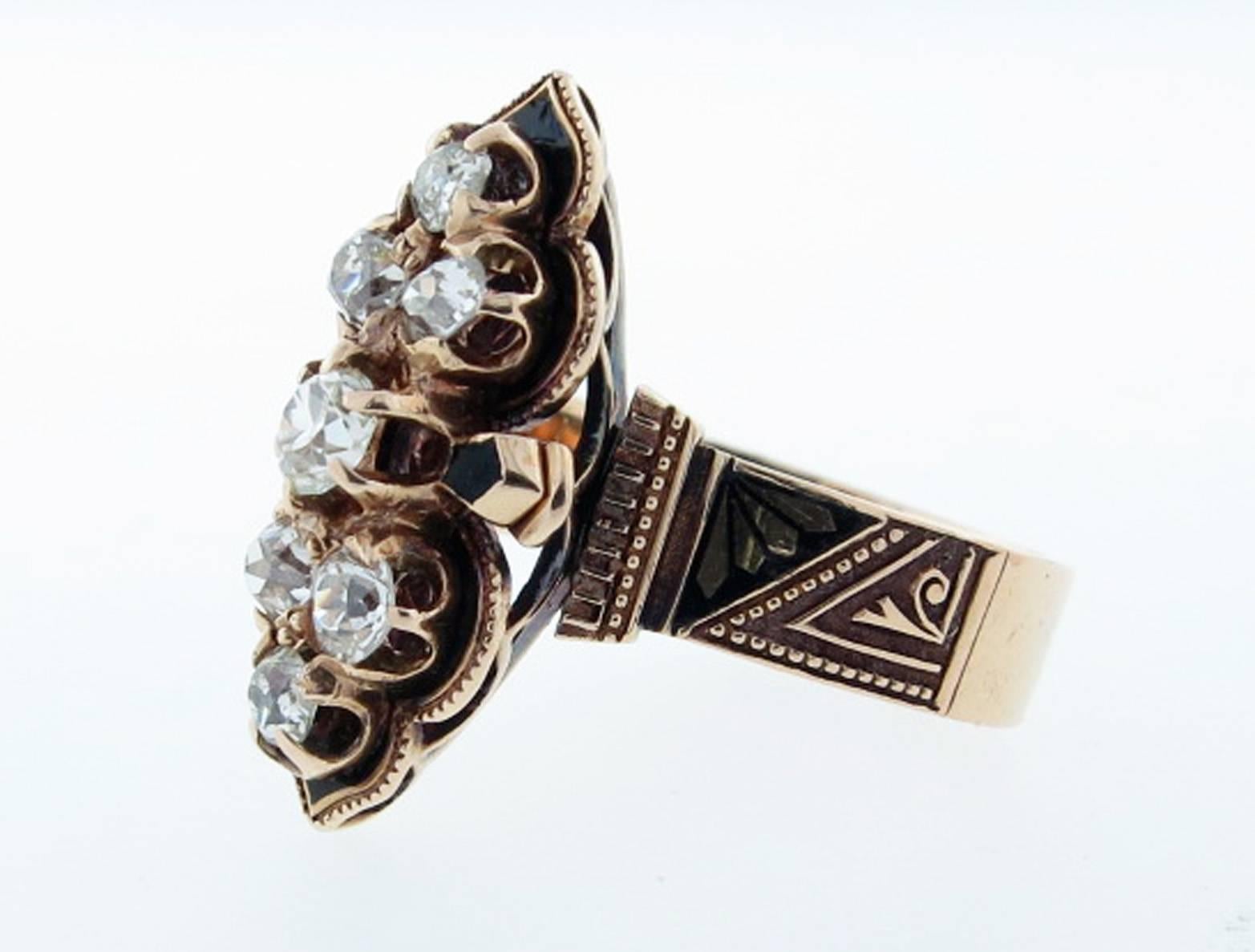 Antique Victorian diamond ring circa 1880 in 14kt. yellow gold. The mount is accented with black enamel tracery work prong set with seven old mine cut diamonds totaling approx ..80cts. Circa 1880. Size 6 1/2 and can be sized.
