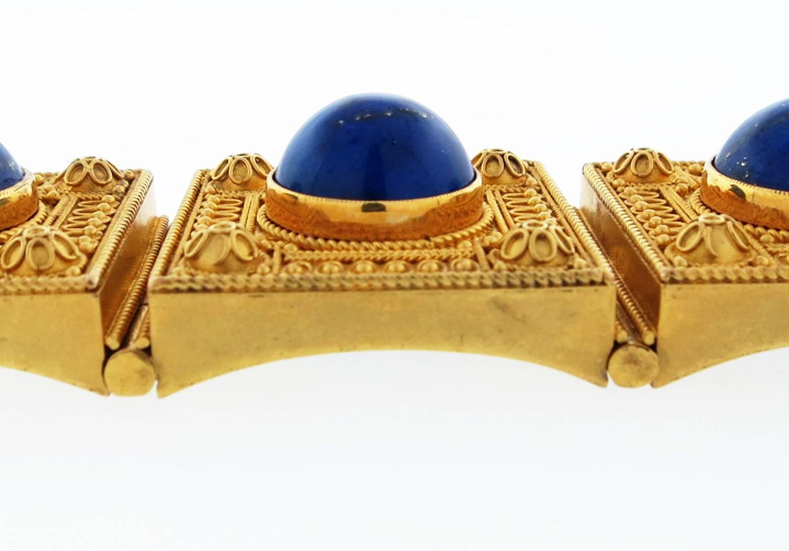 Rarely found in such exceptional condition this Etruscan Revival lapis bracelet is constructed in 14kt. yellow gold. Each of the six dimensional links are set with a fine vibrant lapis lazuli cabochon measuring approx 12.5mm. and has a locket back.