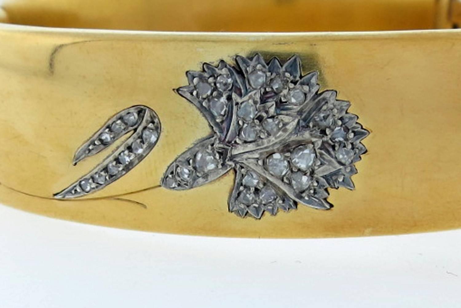 Wonderful  wide18kt. yellow gold hinged bangle bracelet measuring approx .75 inches wide . The smooth half round bracelet is bead set in applique with 29 rose cut diamonds. The bracelet will fit most wrists. French import marks on the hinge.