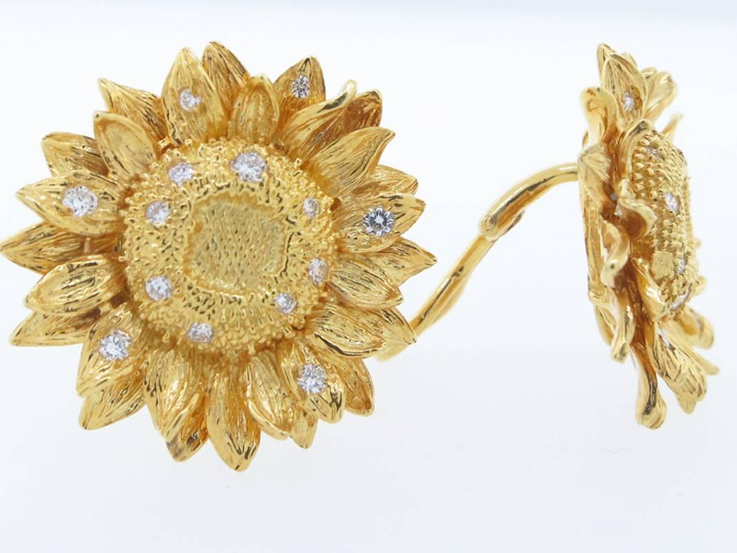 The classic 18kt. yellow gold  sunflower design earrings made by Asprey London. Each clip back earring measures approx 1 inch and is bead set with 13 round brilliant cut diamonds. Posts can be added..