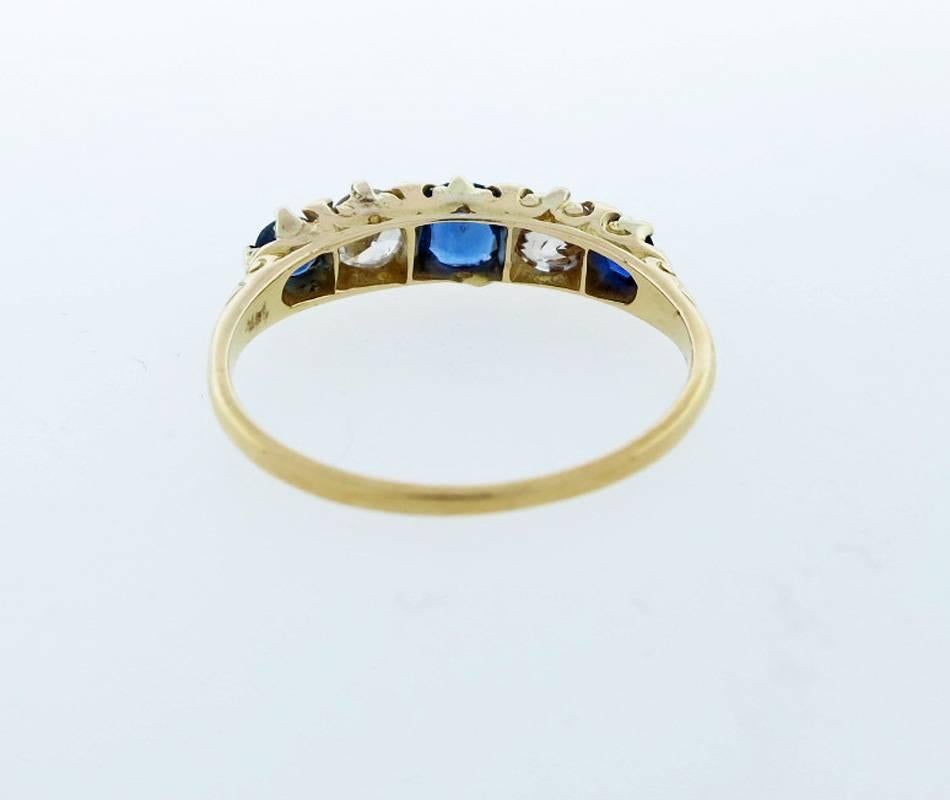 Handmade 14kt. yellow gold alternating natural sapphire and diamond top ring. The center is prong set with a vibrant sapphire weighing approx .25cts. flanked on each side with an old mine cut diamond each weighing approx .23cts with a  .15ct.