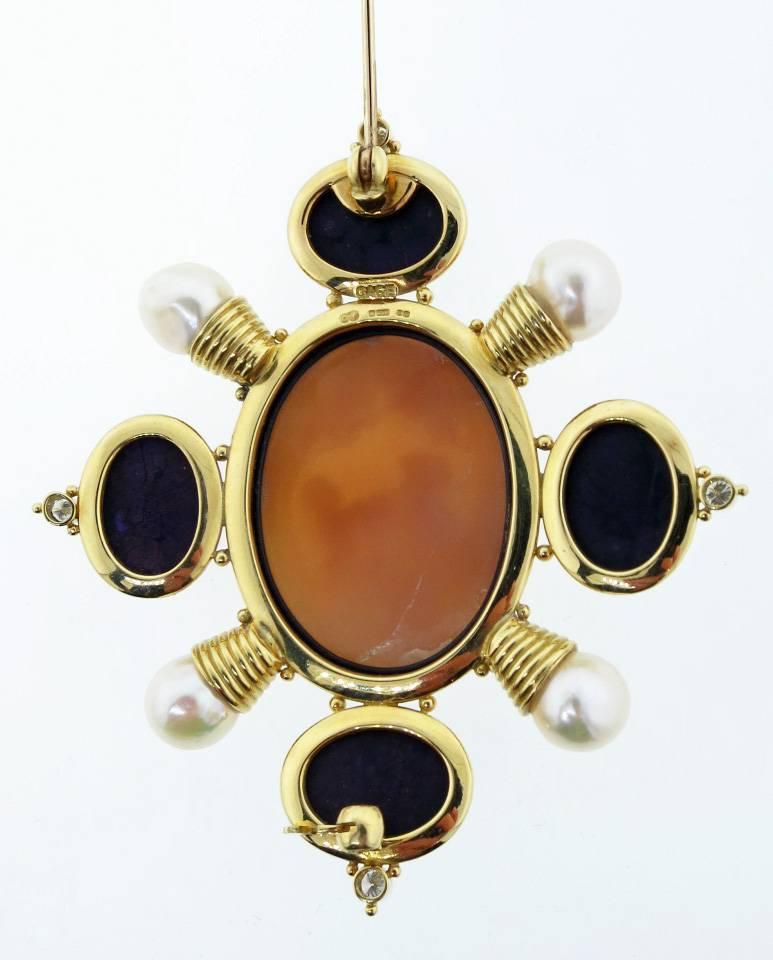 18kt yellow gold handmade brooch made by the internationally acclaimed English jeweler Elizabeth Gage. The brooch measures three inches in length and is set with an oval shell cameo depicting a mother and child. The mount is set with four oval