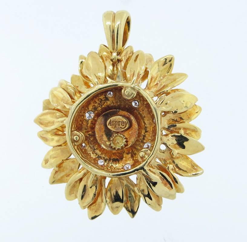 The classic 18kt. yellow gold Sunflower pendant made by Asprey London. The pendant measures approx 2.75 inches and is bead set in the center with 8 round brilliant cut diamonds totaling approx .20cts. 