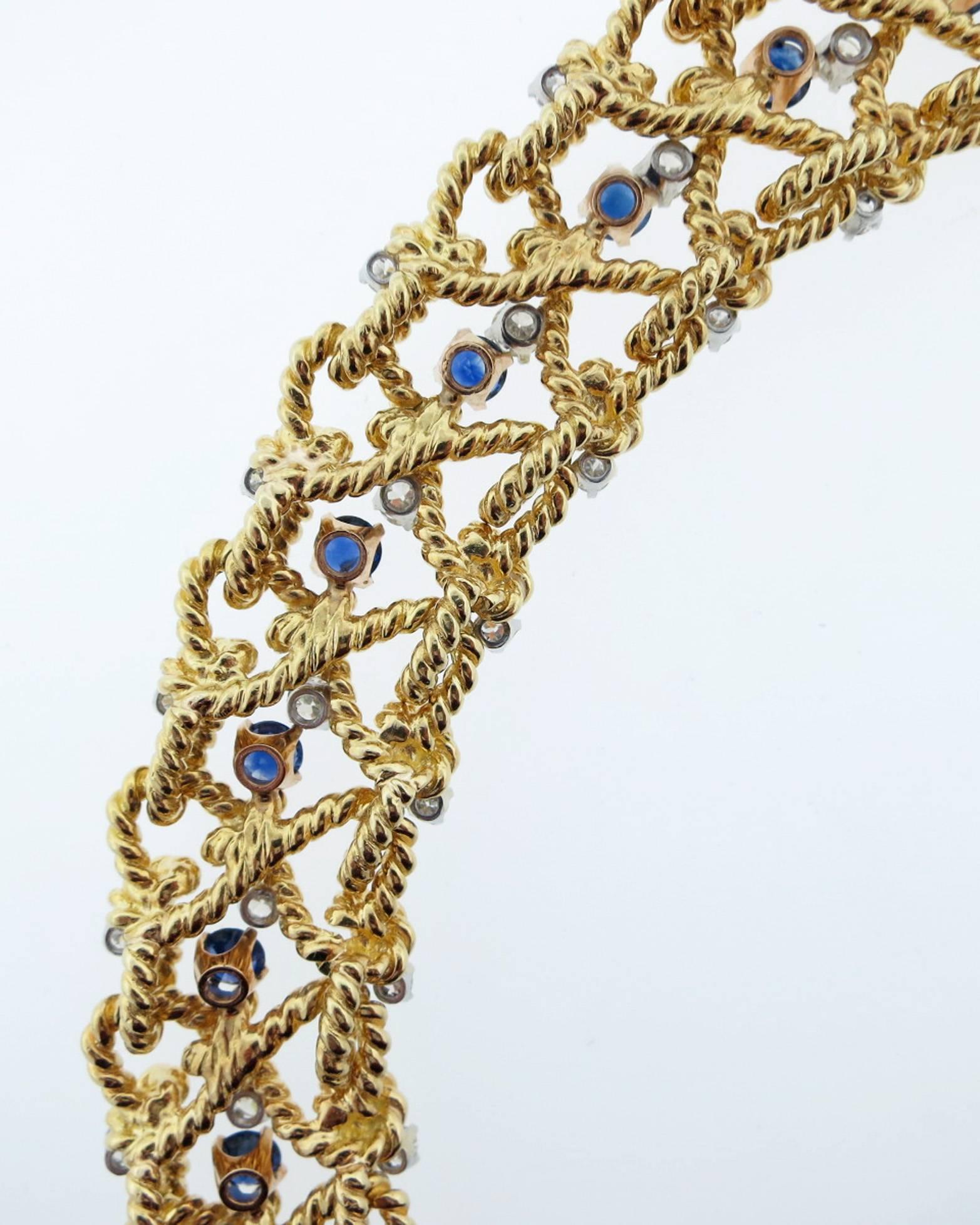 Ladies 18kt. rope designed yellow gold link bracelet measuring 7 1/2 inches in length and over 3/4 inch in width. Set with 36 round brilliant cut diamonds in white gold mounts totaling approx 4.2 cts. and 12 prong set round faceted vibrant blue