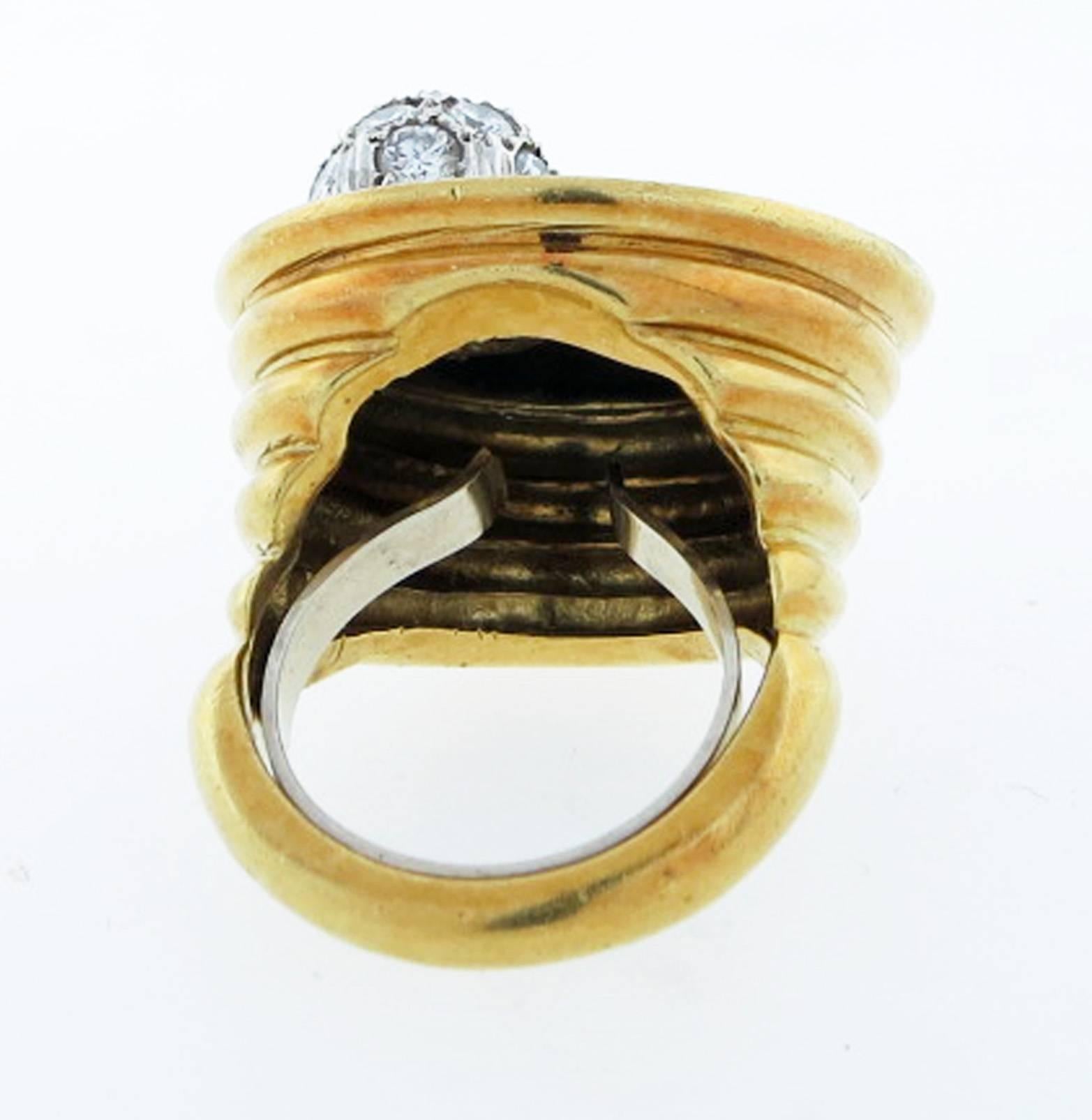 Fantastic and dimensional 18kt yellow gold ring by the American maker Le Triomphe. The ring measures 1 inch across the top and is set with black onyx with a diamond pave ball in white gold, the diamonds total approx .50cts. The tapered sides
