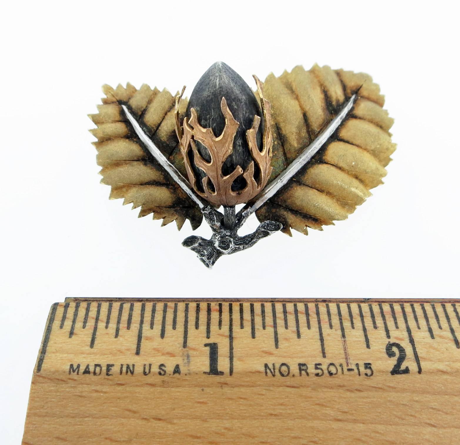  18kt. and silver acorn leaf brooch made by Bucellatti . The brooch measures 2 inches in length  with a double clip back.