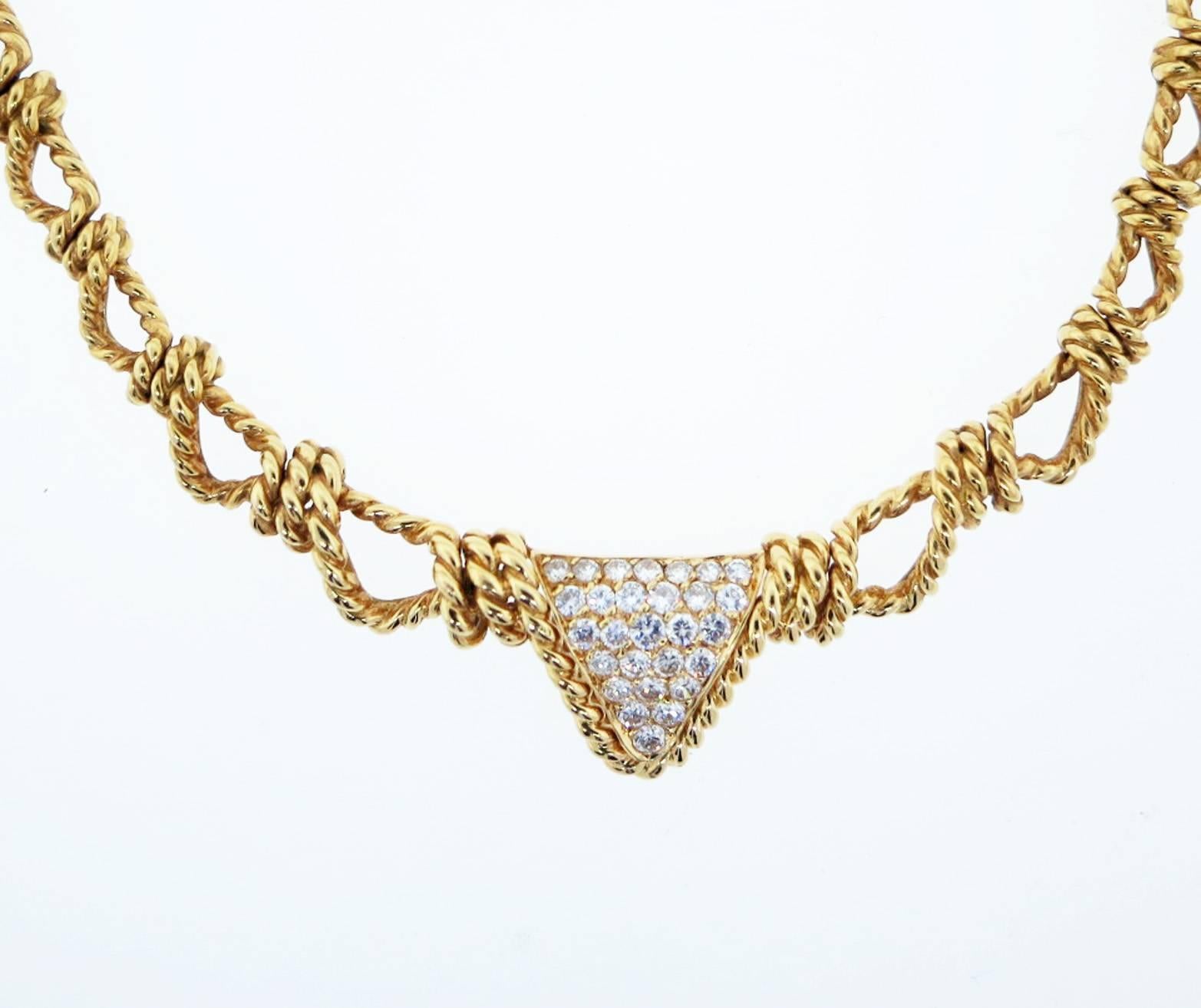 Daytime into evening wearable 18kt. yellow gold necklace. The triangular center plaque is set with 28 round brilliant cut diamonds of the finest quality totaling approx .1.0cts. The necklace measures approx 16 inches. Hidden catch with French