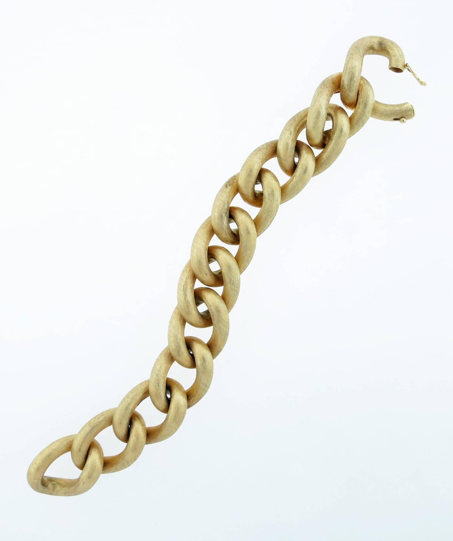 Classic Italian 14kt yellow gold bracelet measuring 8 inches in length weighing 57.8 gr. Each of the 12 curb design links measures approx  3/5 inches wide. Hidden catch .