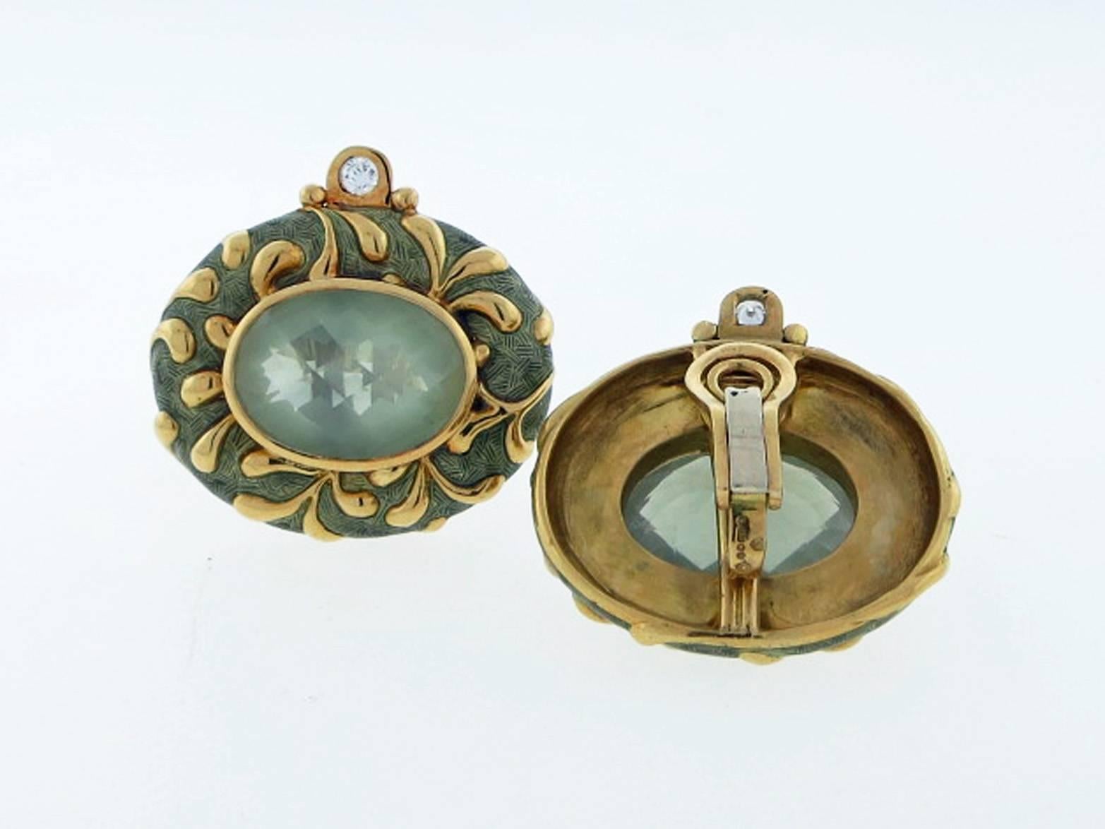 18kt. yellow gold Elizabeth Gage earrings with an enameled frame. Each measuring  approx.1.25 inches in length and  set with an oval faceted top,  subtly hued quartz weighing approx 12. cts. The top of the frame set with a round brilliant cut