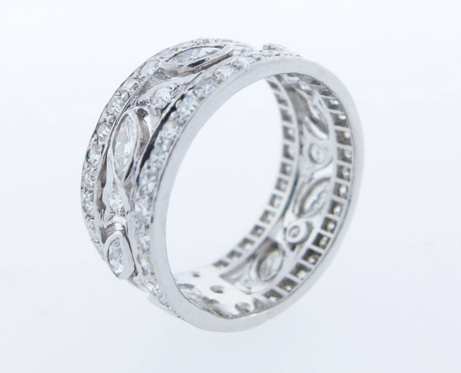 Handmade platinum mount 8.mm. wide diamond band size 6 1/2 . The center is bezel set with 8 marquise cut diamonds and set bead set with 74 round diamonds totaling approx 1.5cts. Circa 1930.