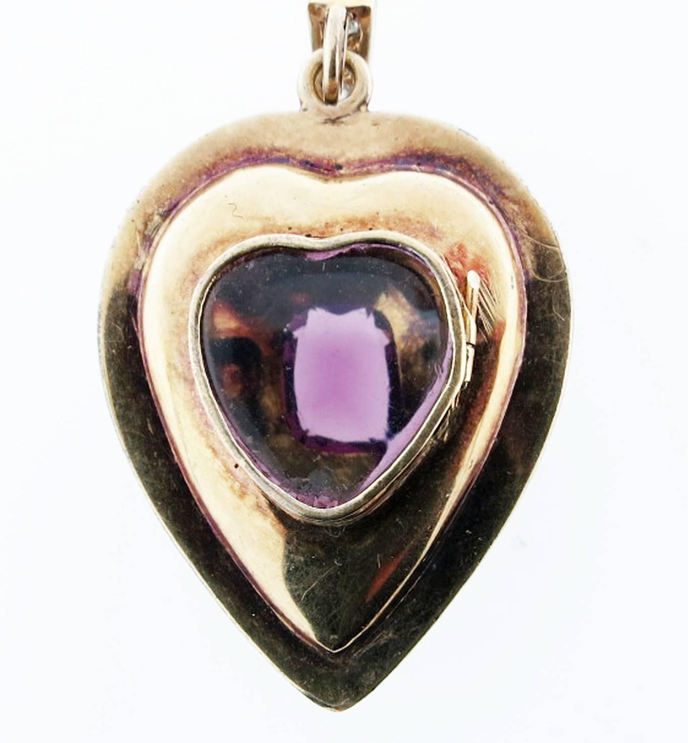 Romantic 18kt. and silver top locket dating from mid 19th century made in France.The top is set in silver with a garnet center and surrounded with rose cut diamonds accented with green enamel detail measuring 1 1/2 inches .
The locket is all