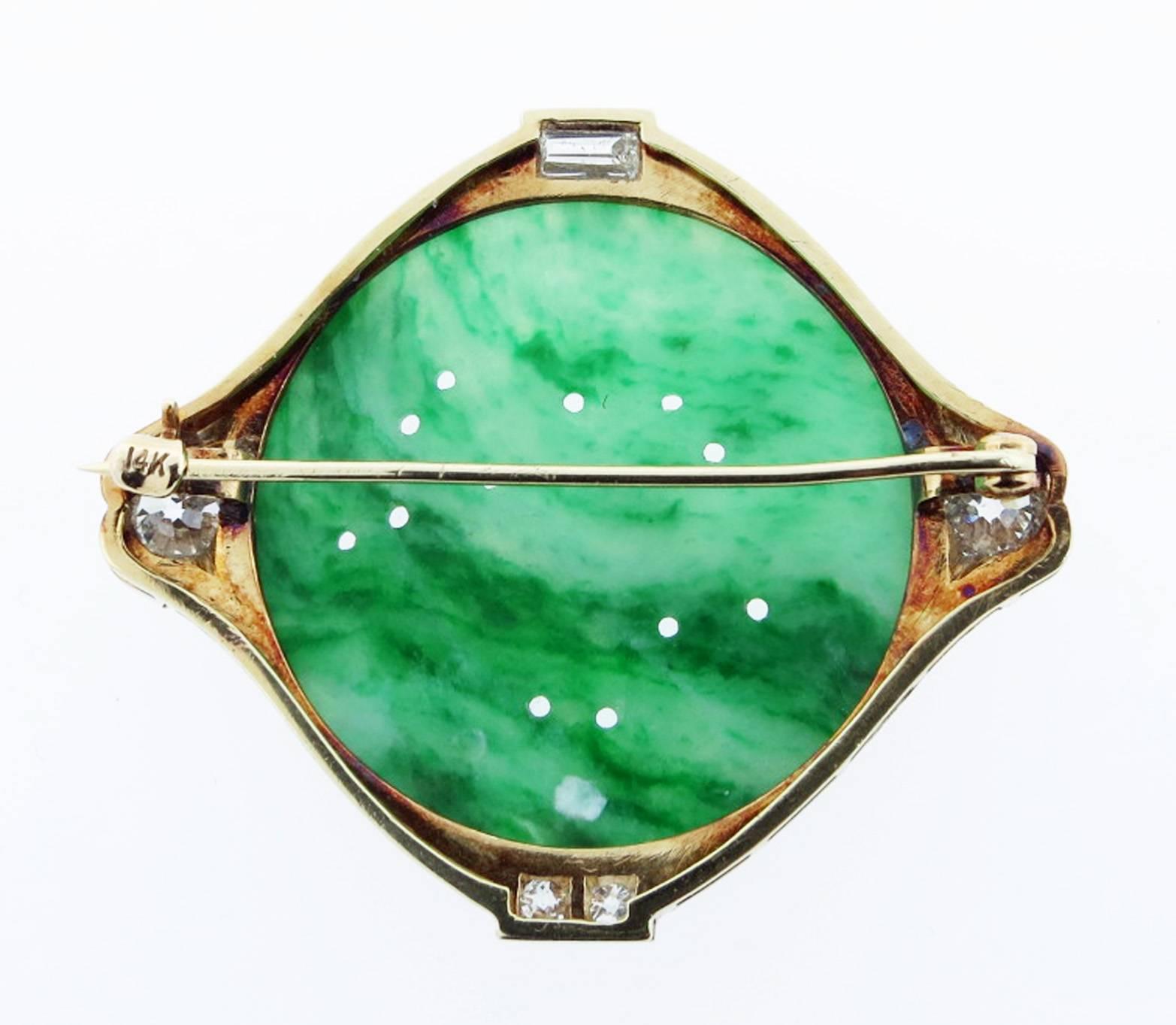 Handmade 14kt. yellow gold beautifully engraved mount jade brooch with a carved bird motif. The brooch measures 1 3/4 inches and is mounted in mill grained white gold with a round European cut diamond on each side totaling  approx .70cts. Set north