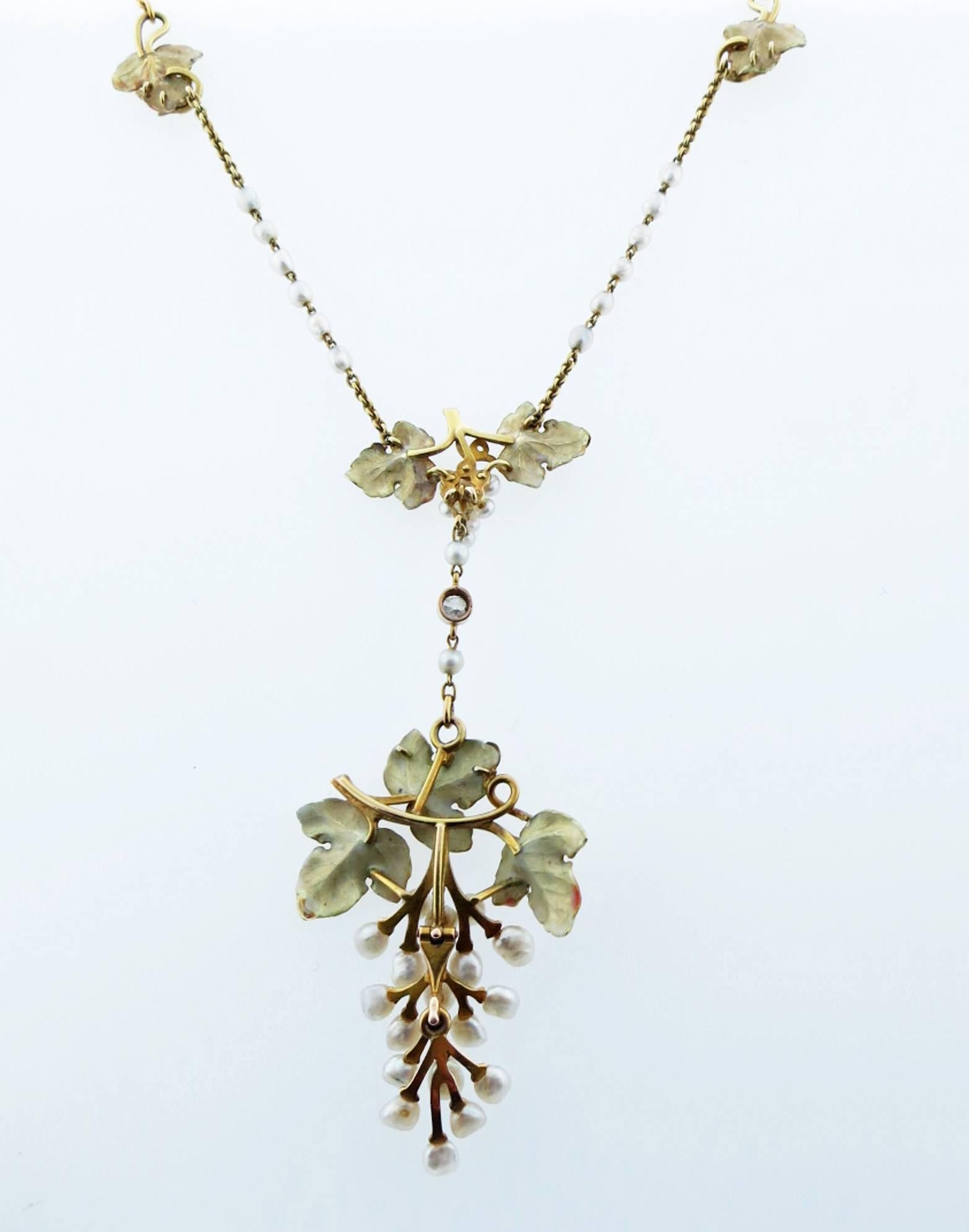Pretty  14kt. necklace in a grape vine design. Circa 1910 in tones of pink and green enamel. The pearls are all natural with a round European cut diamond accent.The necklace measures to bottom of grape cluster to approx 20 inches on the neck. 
