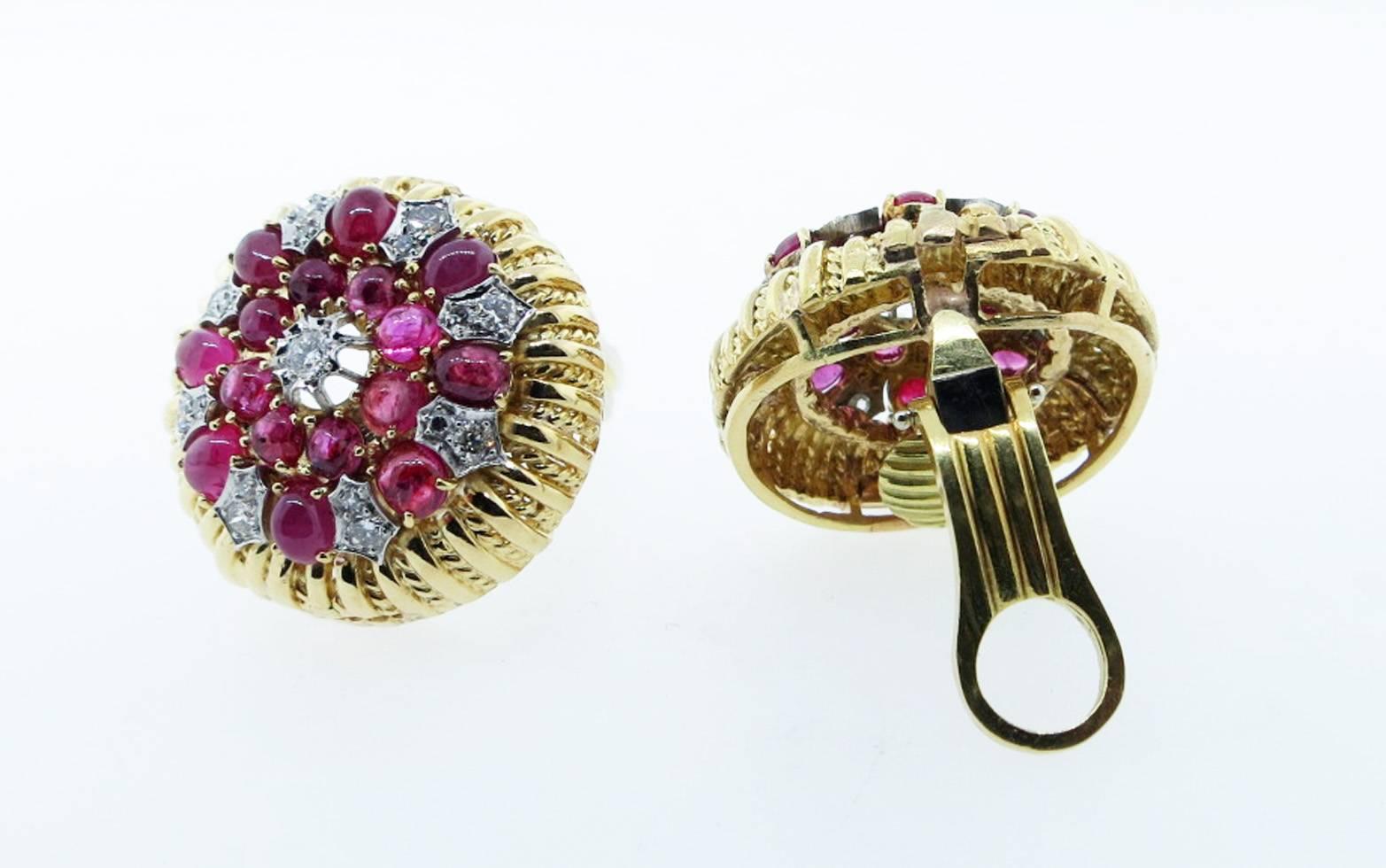 Fluted edge 18kt. yellow and white gold earrings. Each earring measures approx 1 inch and is set with 16 round natural rubies totaling approx 1.75cts. and 17 round brilliant cut diamonds totaling approx .50cts. The earrings are clip back posts can
