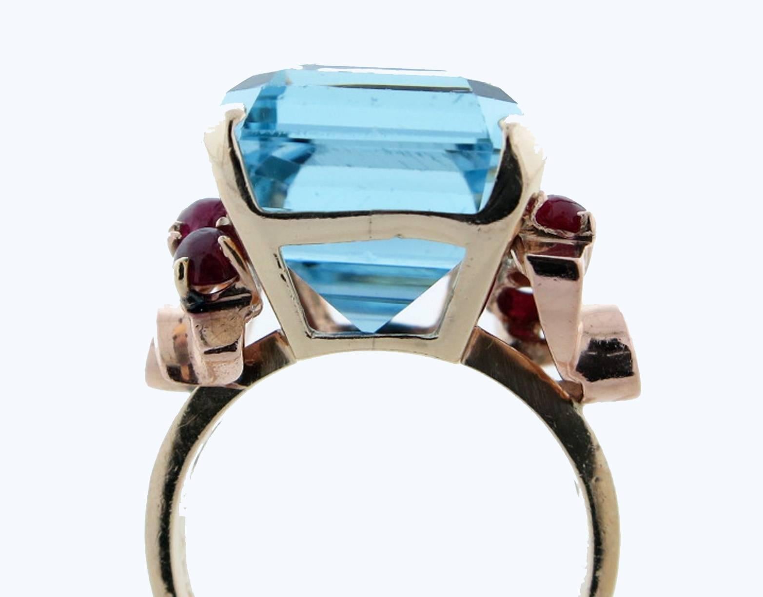 14kt. yellow gold mount aquamarine ring circa 1940. The center is prong set with a faceted natural aquamarine weighing approx 15.0cts. Each side is set with three cabochon natural rubies totaling approx 1.2cts. Size 6 1/2 and can be sized.