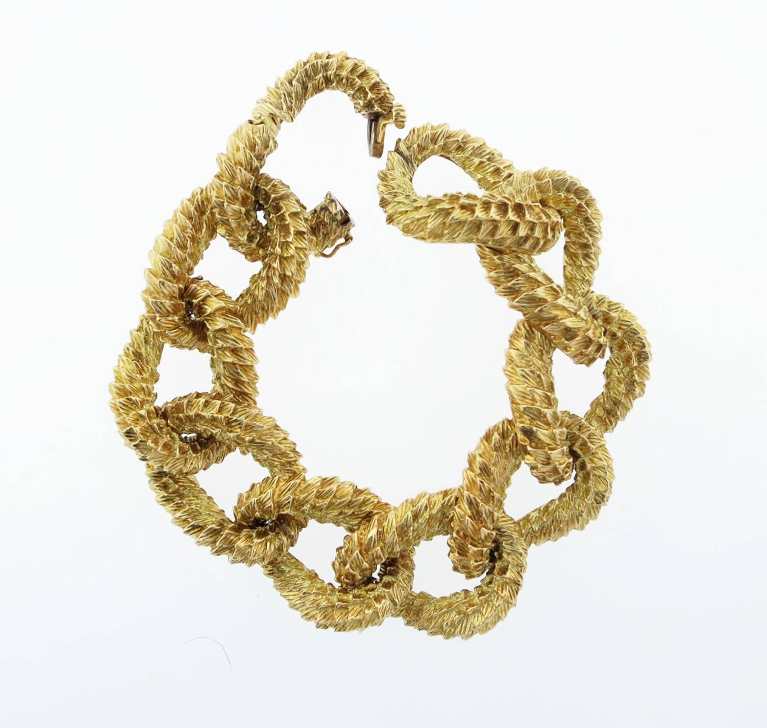 Crunchy heavy 18kt. yellow gold textured curb link bracelet by Tiffany & Co. circa 1970.The bracelet measures 8 inches in length and will fit as a 7 inch bracelet  and weighs 141.1 gr. Each link measures approx. 1 inch in length. Hidden catch