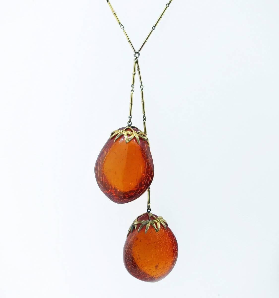 Great 14kt. link necklace with bamboo motif capped natural  amber drops. Light in weight but with lots of visual impact . The necklace drops to approx 20 inches. Circa 1900.