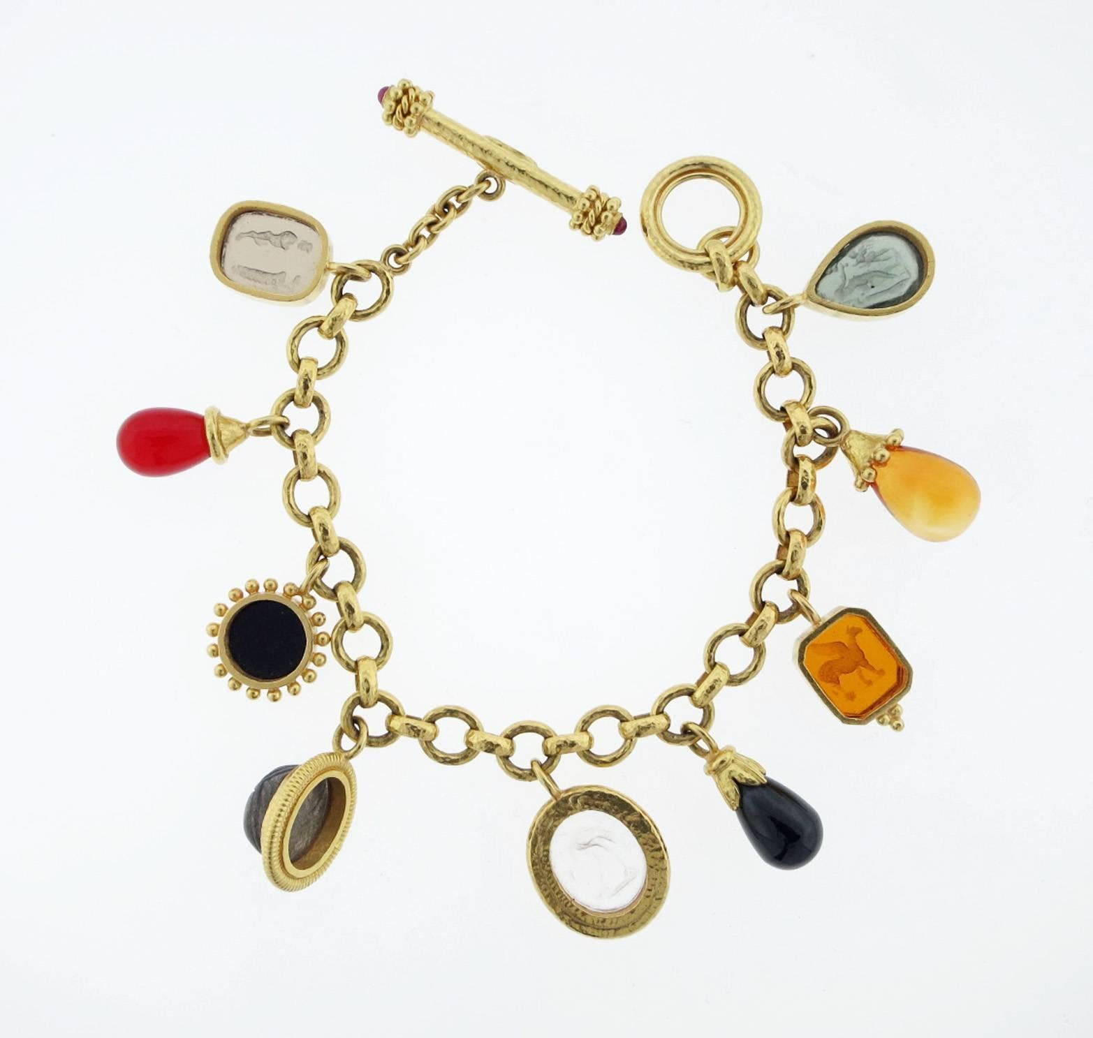 Impressive 18kt. yellow gold link charm bracelet made by Elizabeth Locke consisting of various Venetian intaglios and semi-precious stones .
The bracelet measures 8 1/2 inches in length with a toggle catch. The bracelet weighs 56.9 gr. Excellent
