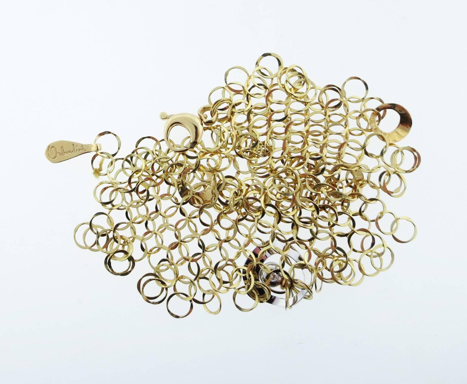 Incredibly constructed 18kt yellow gold fluid bracelet made by the Italian jeweler Orlando Orlandini. The flowing hand hammered interlocking links have a diamond  bezel set charm accent in white gold. The bracelet measures 2 inches at the center and
