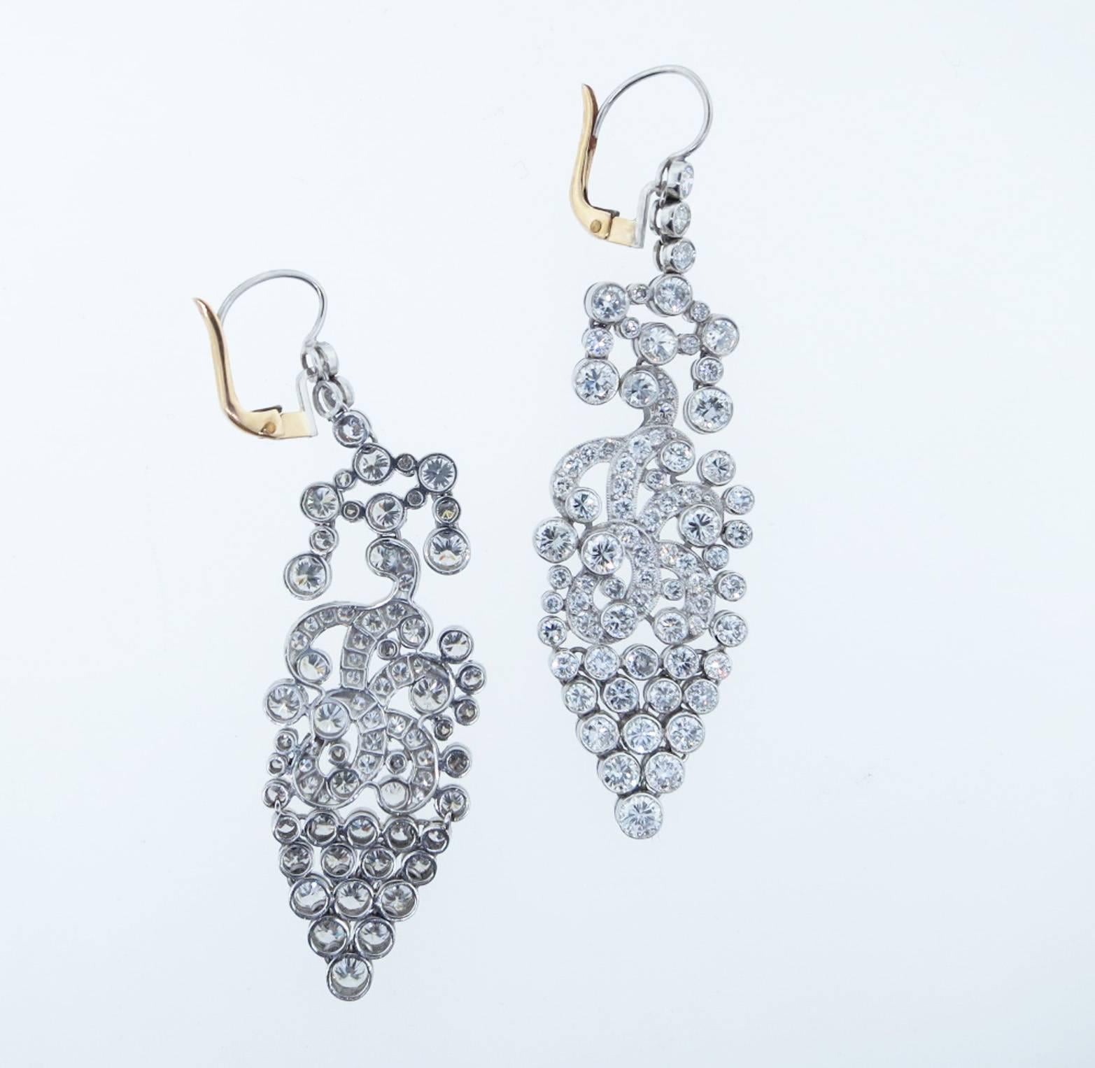 Sensational handmade drippy diamond chandelier earrings. Each lever back earring is bezel and bead set in fluid articulated platinum mounts with 75 matching round brilliant cut diamonds totaling approx 7.0cts. The earrings measure 2.5 inches in
