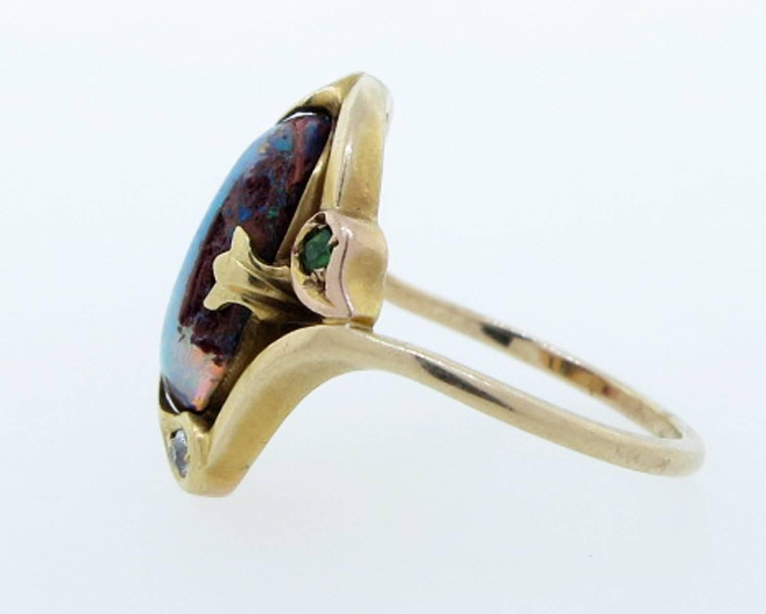 Rare American made Arts and crafts boulder opal, diamond, ruby and green garnet ring circa 1910 in a flowing handmade 14kt. yellow gold mount.  The ring is size 5 and can be sized.