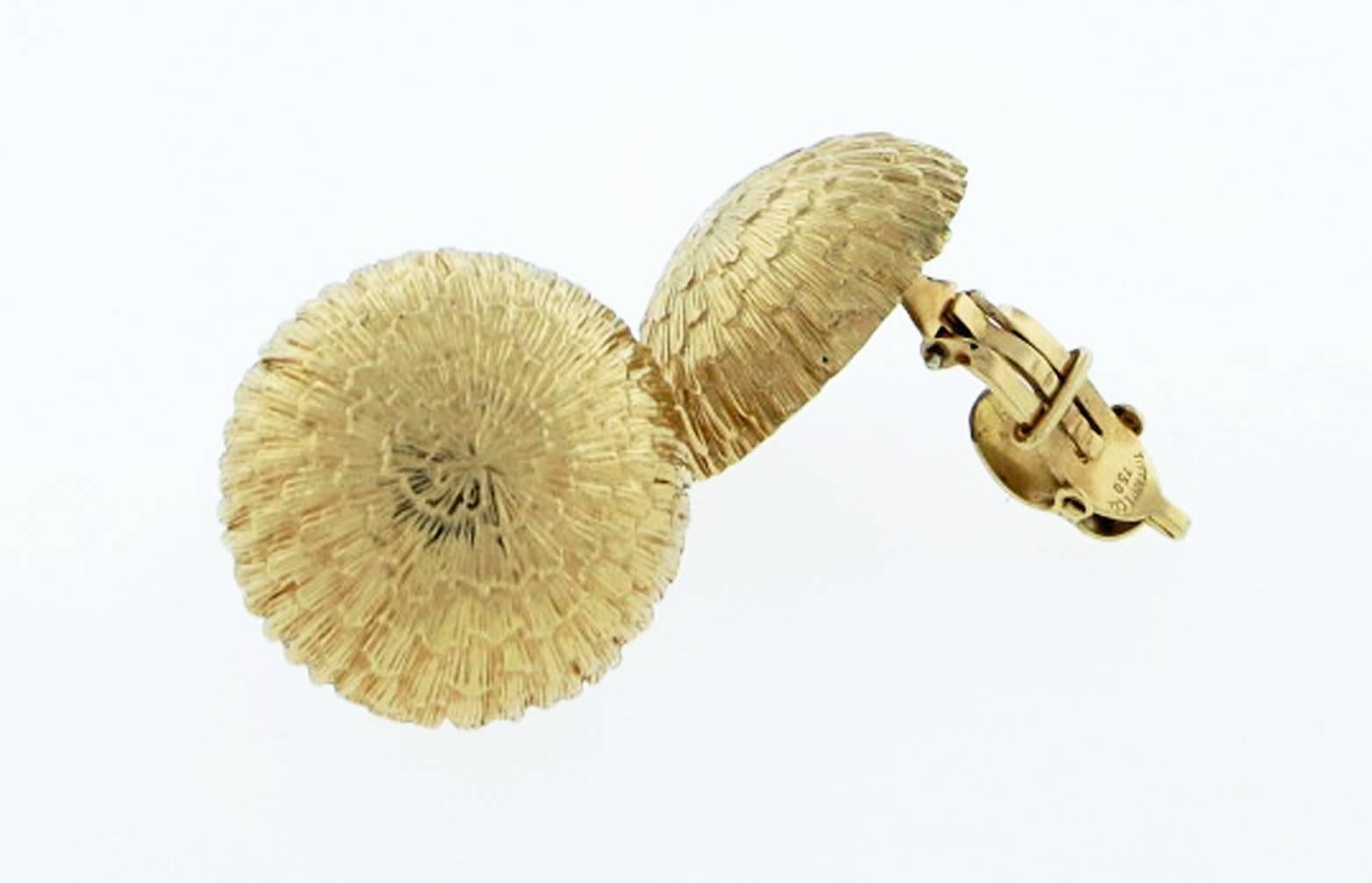 Clip on half dome textured Tiffany & Co. 18kt. yellow gold earrings. Each earring measures approx 1 inch in diameter. The earring backs have hinged pads that fit comfortably on the ear. 