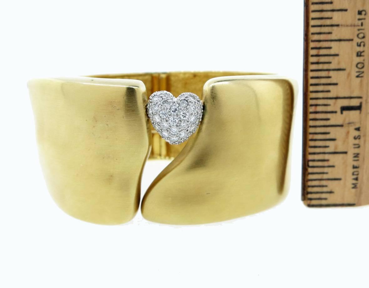 Substantial 18kt. yellow gold matte finish free form contemporary organic design cuff made by Marlene Stowe . The bracelet measures approx 1.25 inches in width and is paved in white gold with a diamond heart at the front. The bracelet weighs 128.1