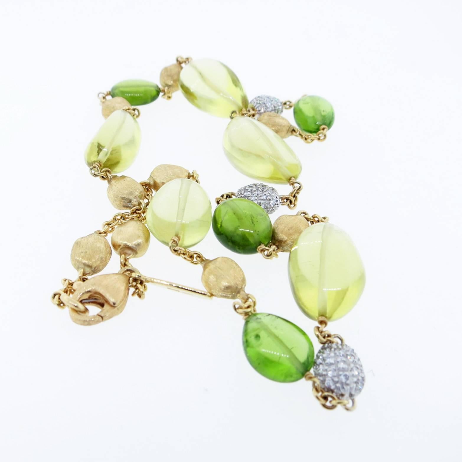 18kt. yellow gold link necklace made by the Italian jeweler Marco Bicego. The 16 inch necklace is strung with a mix of  polished citrine and peridot beads mixed with  Marco Bicego signature gold beads . There are three white gold beads paved with
