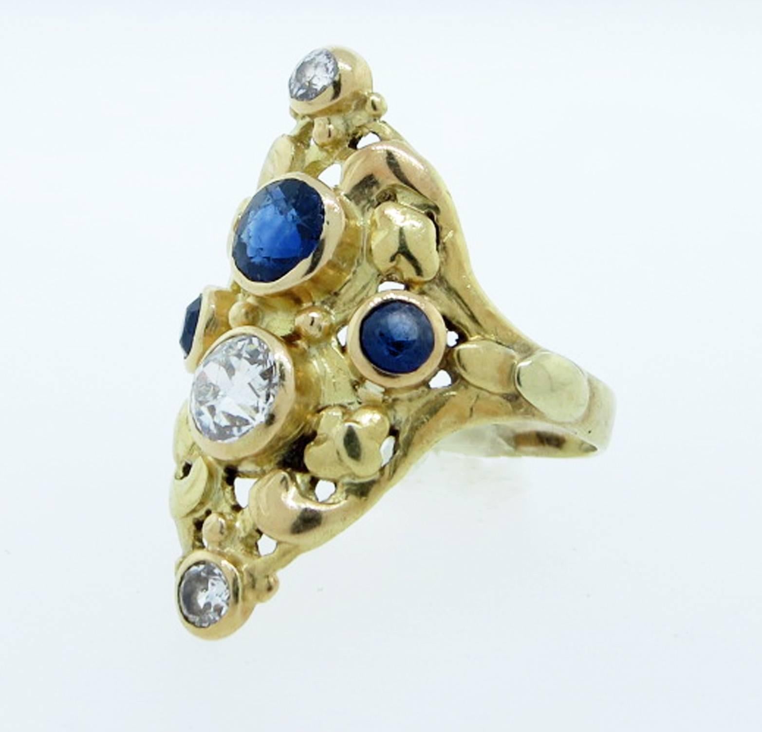 Ladies handmade 14kt. yellow gold Art Nouveau ring circa 1910. The large center old mine cut diamond weighing approx .50cts. The large old cut fine blue natural sapphire weighing approx .60cts. The side smaller diamonds total approx  .12cts , the