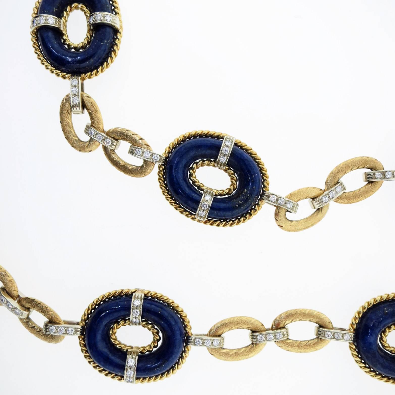 Substantial in weight and glamorous in design 18kt. yellow and white gold 29 inch link necklace consisting of 9 oval natural Lapis Lazuli rope edge links. The connector links and Lapis links are bead set in white gold with 136 round brilliant cut