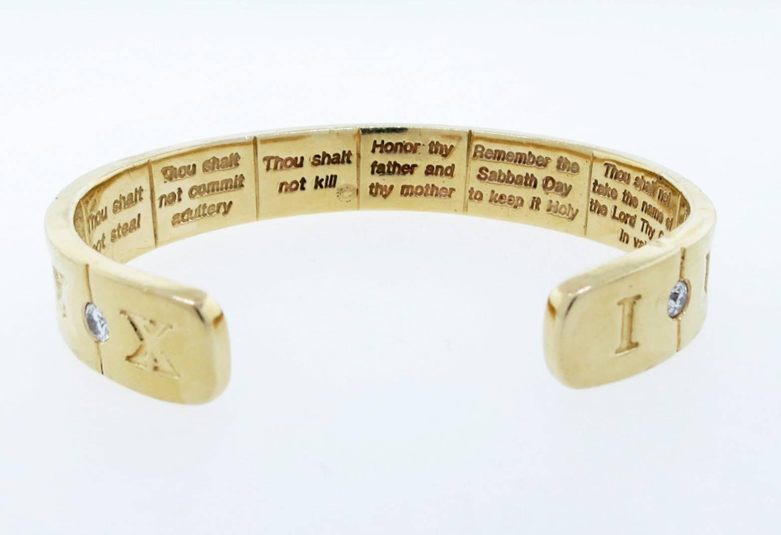 Extraordinary 14kt. yellow gold custom made cuff bracelet with Biblical engraving. The outside of the bracelet is deeply engraved with Roman numerals alternated with nine round brilliant cut diamonds totaling approx 1.65cts. grading VS clarity G