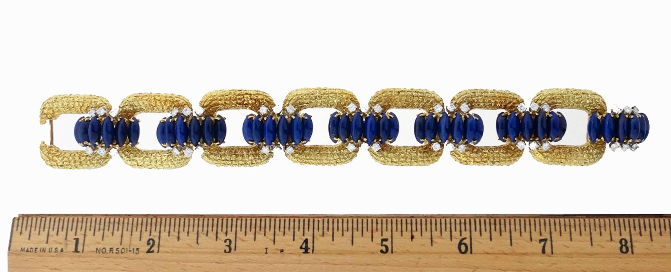 High style 18kt. crunchy yellow gold bracelet made by La Triomphe circa 1960. The bracelet measures approx 8 inches in length and 1 inch in width. Each curved connector link is prong set with six marquise shape natural rich blue lapis lazuli and