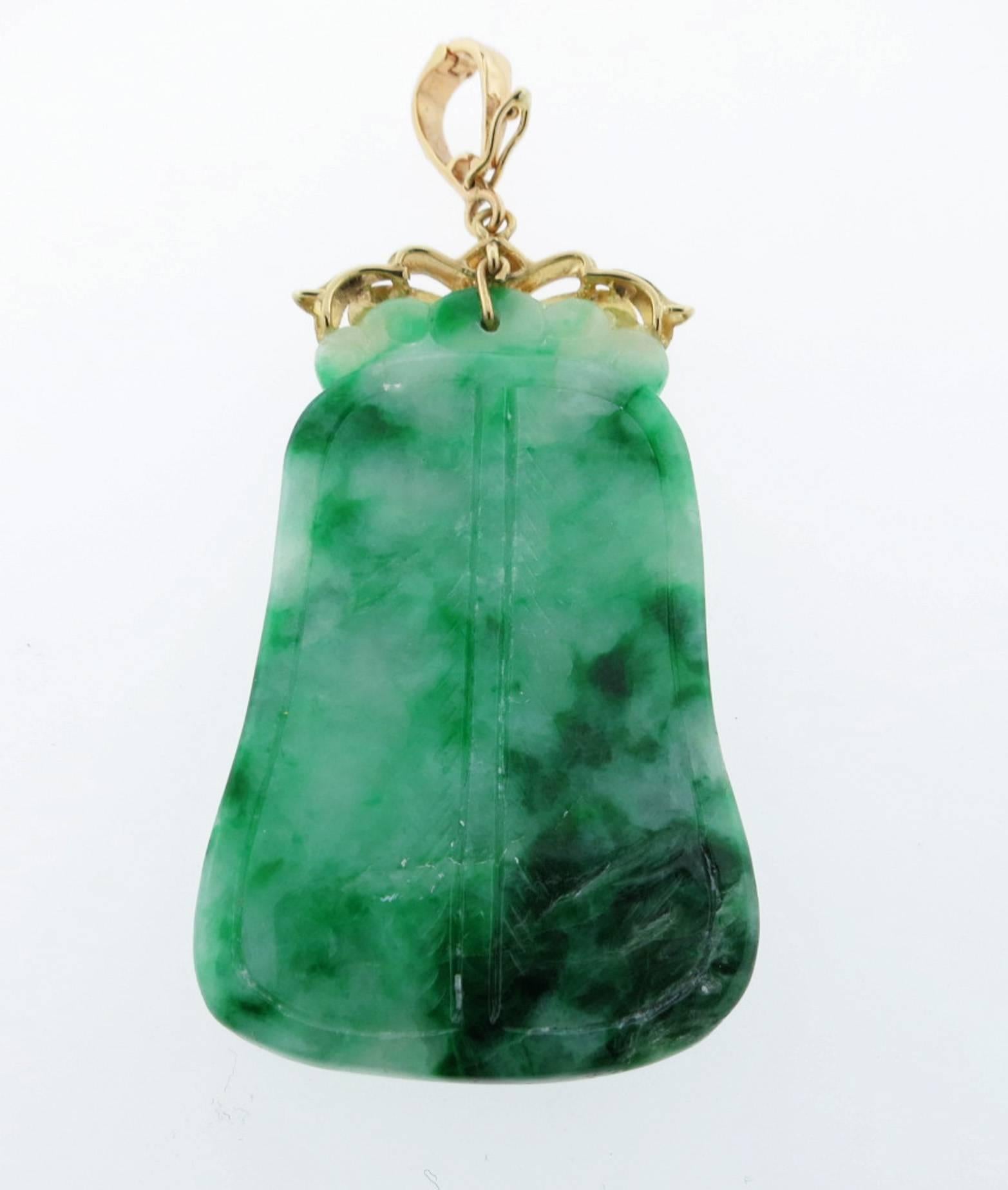 14kt. yellow gold carved jade pendant enhancer measuring 2 inches in length. The enhancer top allows it to be worn with various chain thickness or pearls.