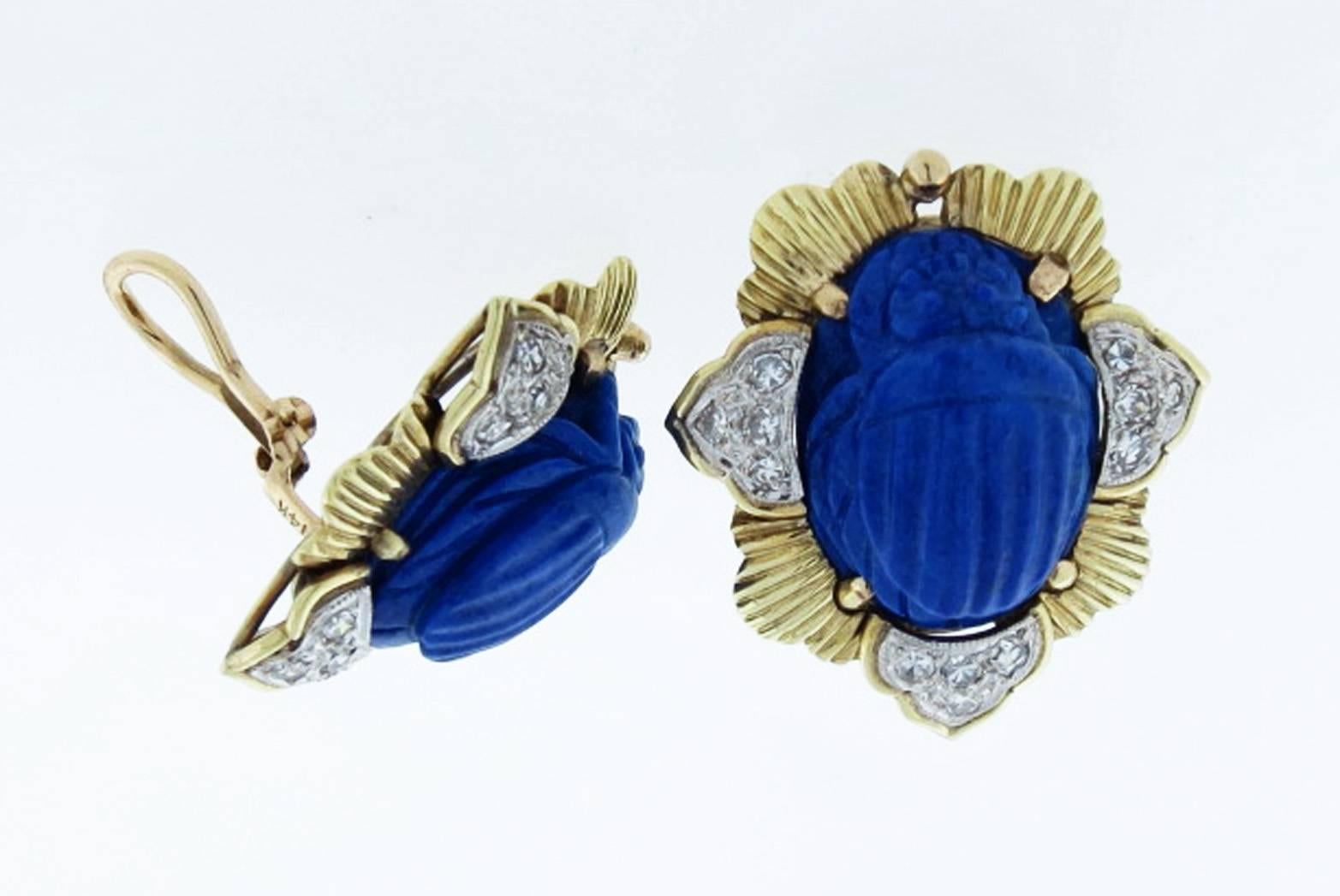 14kt. yellow gold carved Egyptian scarab motif lapis earrings. Each clip back earring measures approx 1.25 inches in length and is bead set in white gold with twelve round brilliant cut diamonds totaling approx .35cts. Posts can be added.