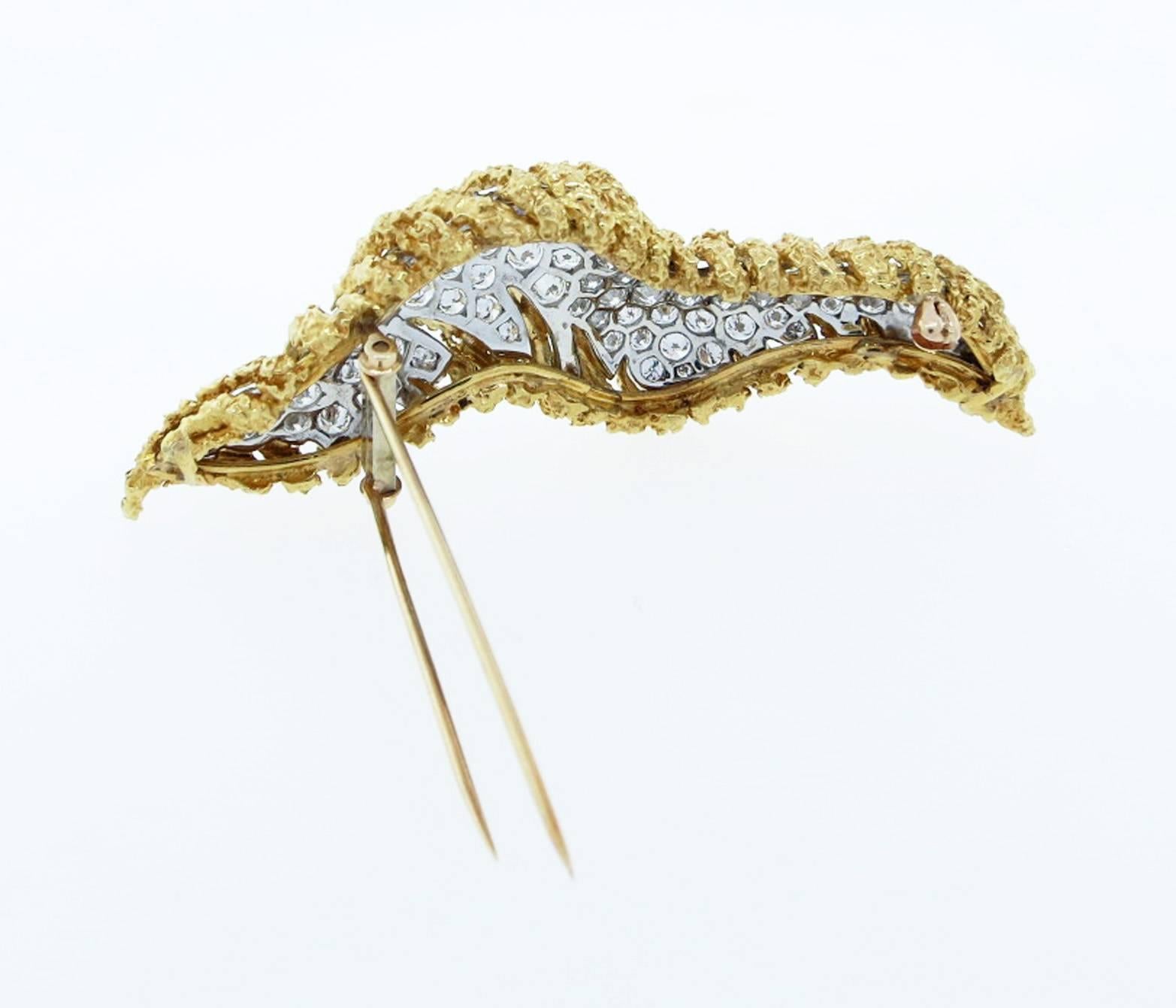 Beautiful crunchy design 18kt. yellow gold brooch measuring approx 3 inches in length and weighs 31.2 gr. with a white gold inset that is bead set with 73 round brilliant cut diamonds totaling approx 4.5cts. grading Vvs1-Vs1 clarity F-G color.