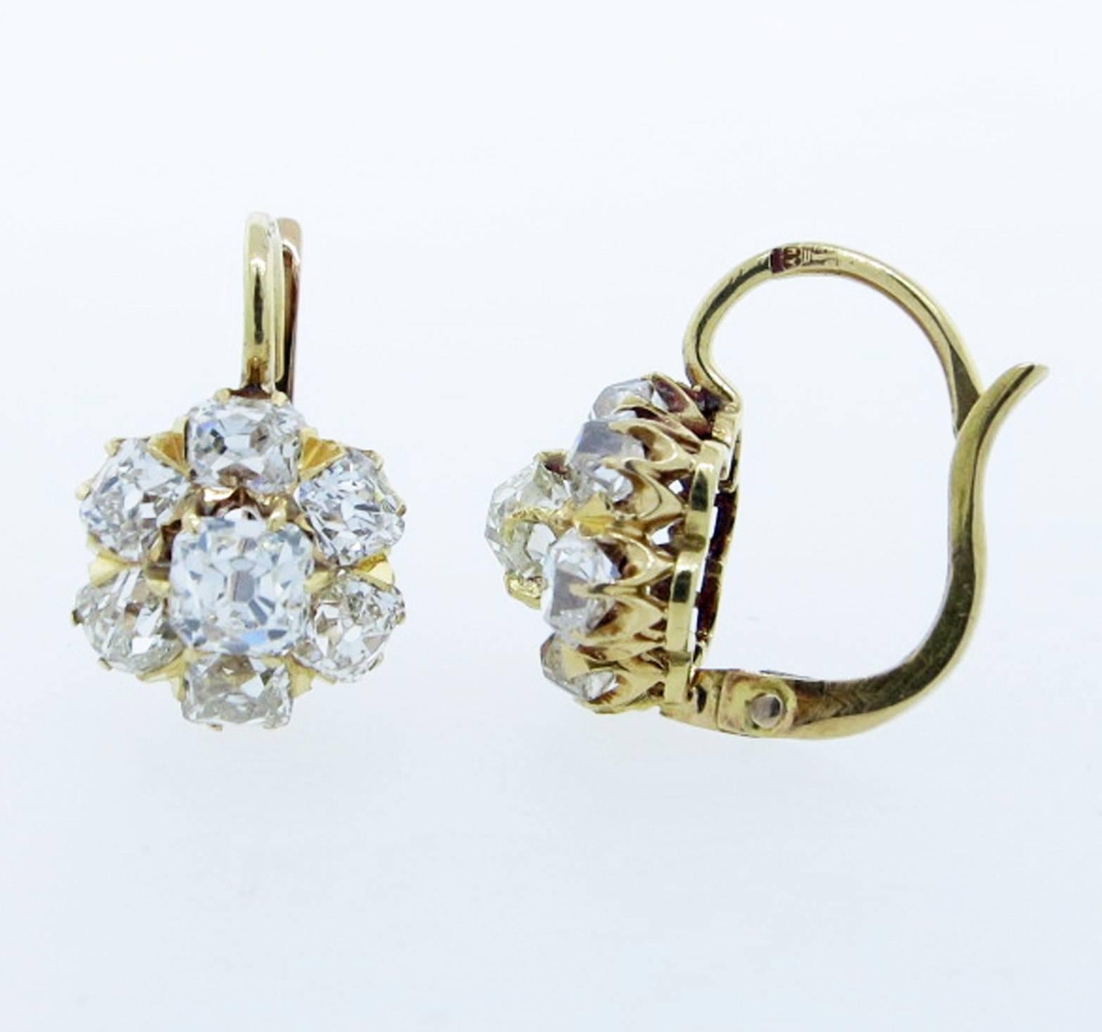 Vintage Victorian 14kt. yellow gold earrings. Each earring is prong set with a cushion cut diamond weighing approx .30 cts. surrounded with six cushion cut diamonds totaling approx .70cts. totaling approx 1.0cts. The diamonds grade Vs clarity H-I