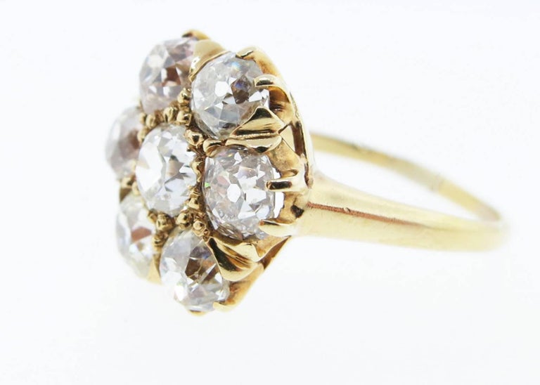 Scintillating 14kt. yellow gold antique diamond ring prong set with 7 round old mine cut diamonds totaling approx 2.8cts. grading VS -SI2 clarity. Size 6 1/2 and can be sized. Circa 1880.
