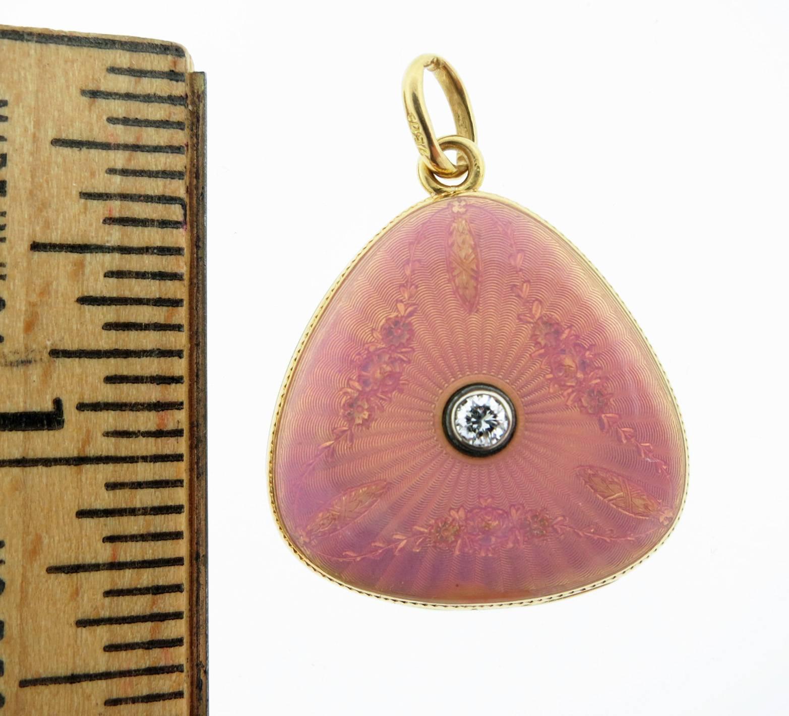 Lovely Art Nouveau double frame 18kt. yellow gold, feminine and softly curved peach color guilloche enamel locket. The locket measures approx 1 1/4 inches in length and is bezel set with a center diamond weighing approx .20cts. Circa 1900.