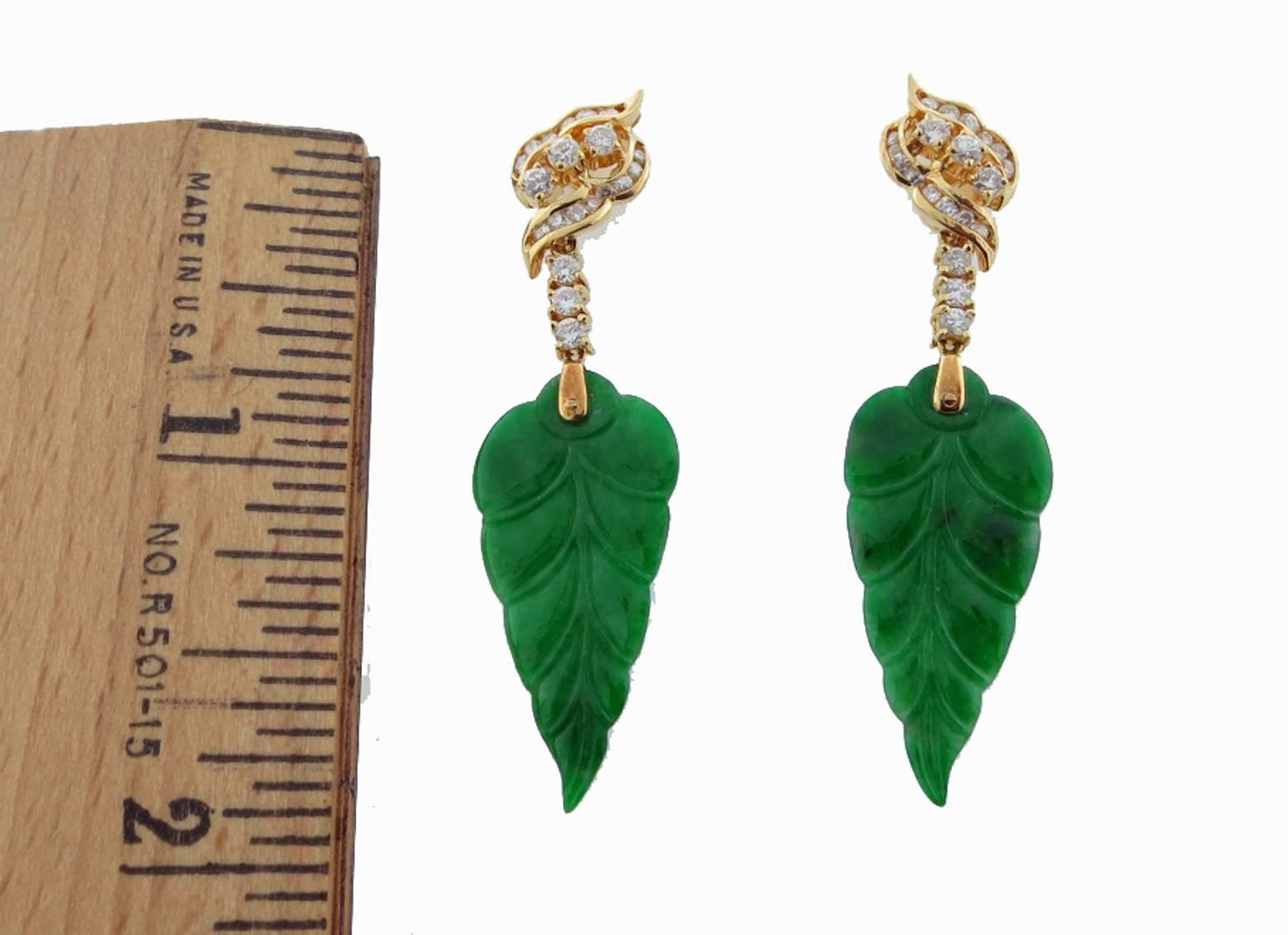 Old carved natural jade leaf earrings with contemporary diamond tops. Each earring  measures approx 2 inches in length mounted in 18kt. yellow gold . Each leaf is carved on both sides and topped with 20 round brilliant cut diamonds in articulated