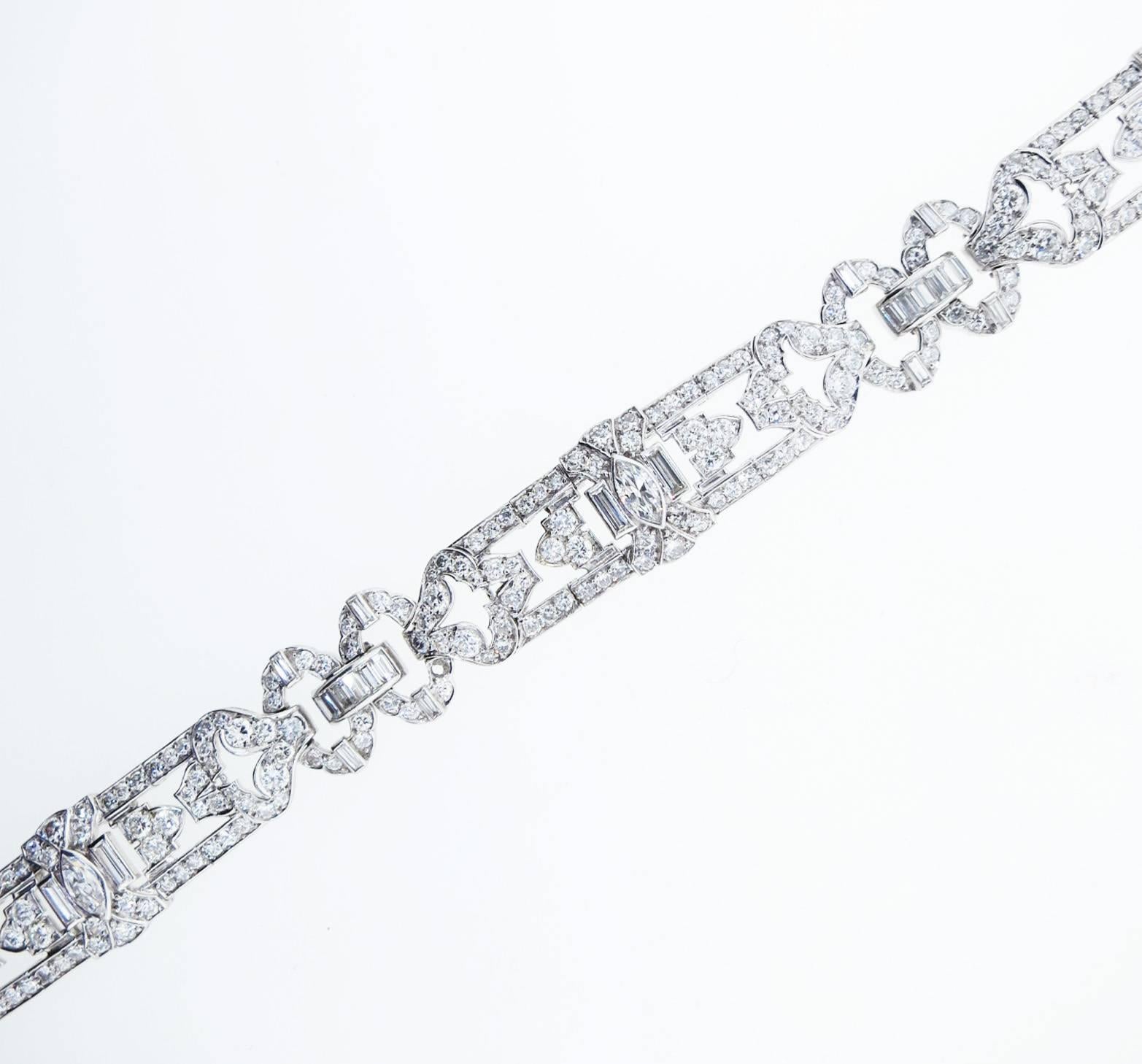  Platinum J.E. Caldwell diamond bracelet circa 1950. The bracelet is bead set in three sections  with 270 round Brilliant cut diamonds, 36 baguette cut diamonds and 3 marquise cut diamonds totaling approx 10cts. The diamonds grade VS clarity G-H