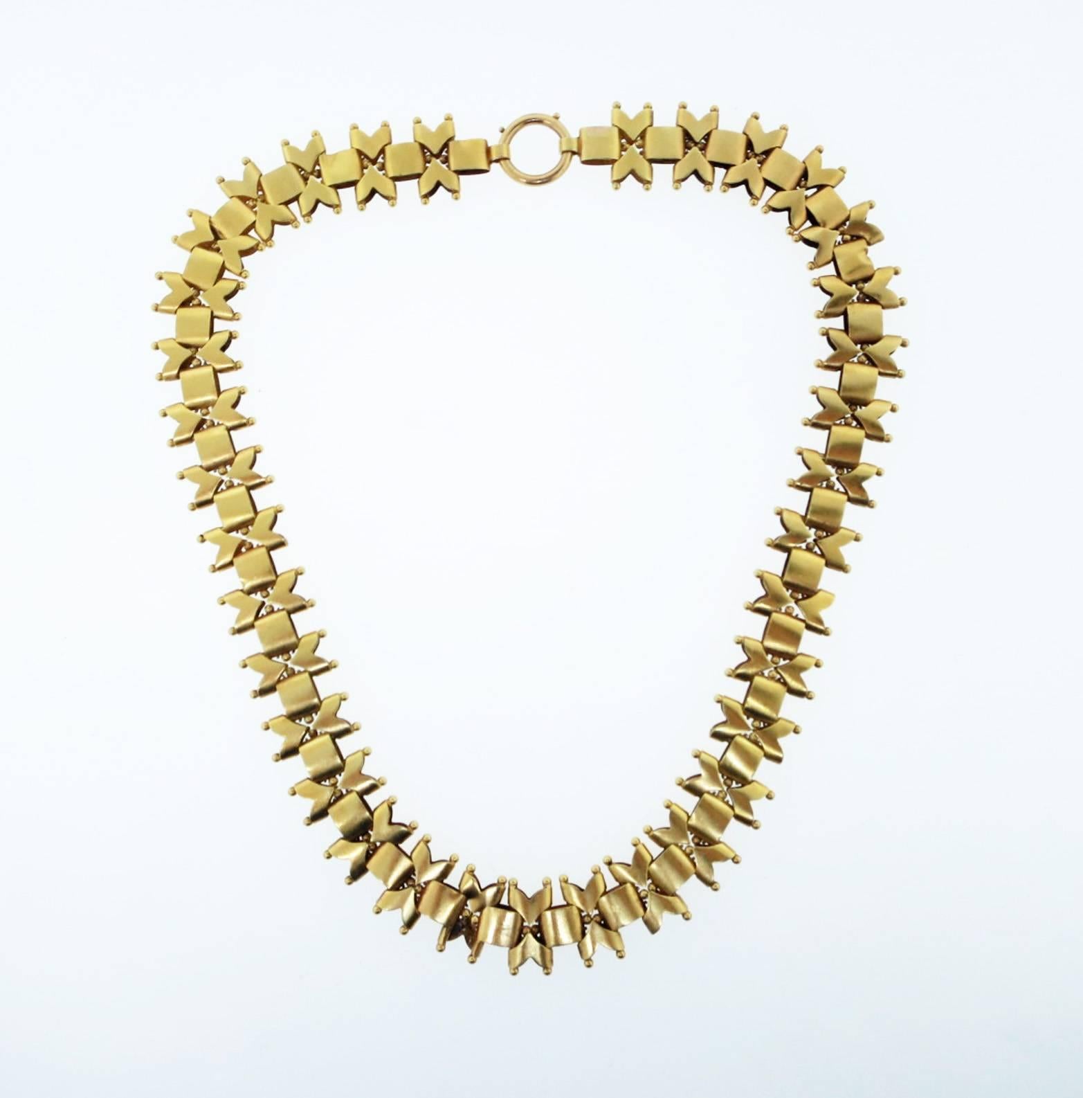 Intricate and bold softly finished  14kt. yellow gold link Victorian necklace measuring 18 inches in length and 3/4 inches in width with granulation detail circa 1880.