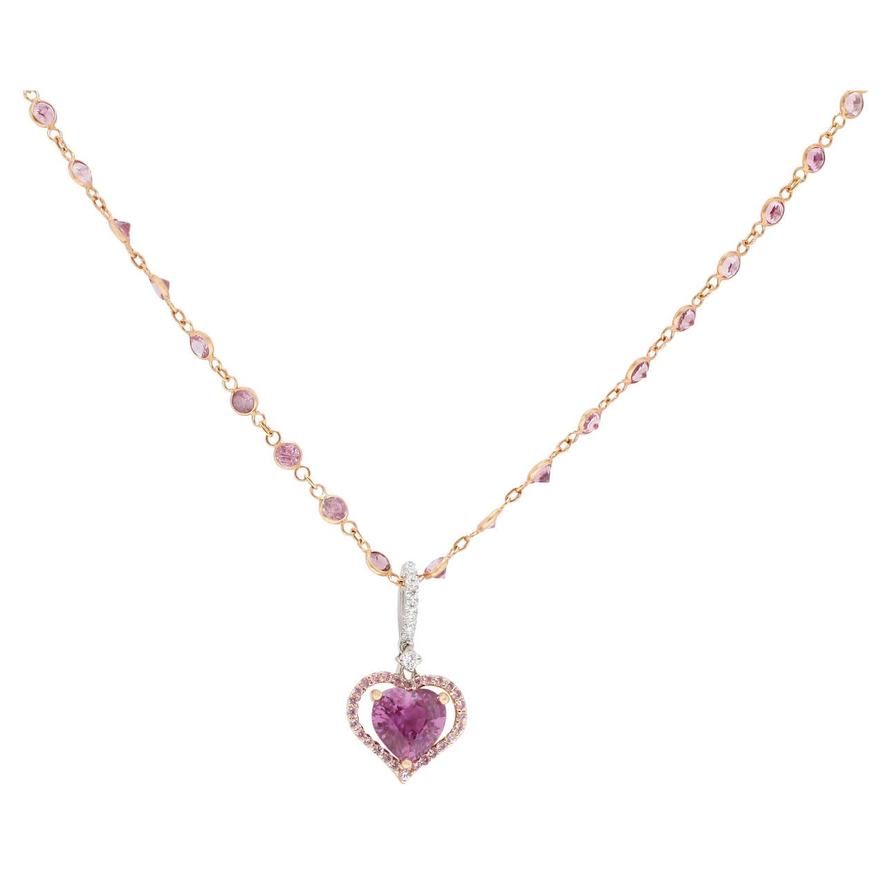 This beautiful Burdeen's Jewelry Custom 18K Rose & White Gold Pink Sapphire Heart with Halo Pendant on a Pink Sapphire Station 20