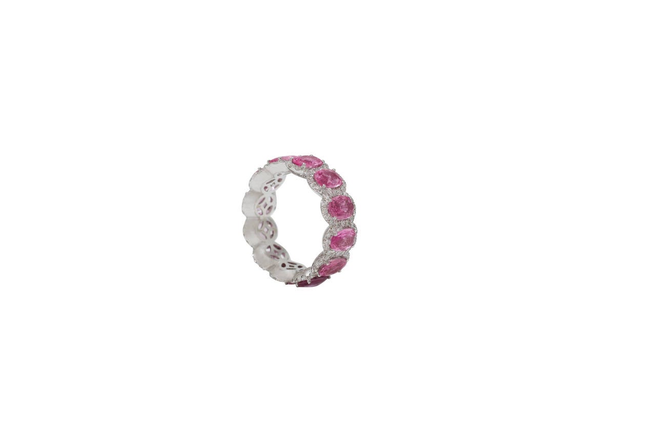 This ring is a Burdeen's Jewelry, Magnificent Oval PInk Sapphire & White Diamond Halo Eternity Band, set in 18K White Gold. The color of pink is breathtaking & the diamond halo's just make each center stone pop !  This band is elegant, comfortable,