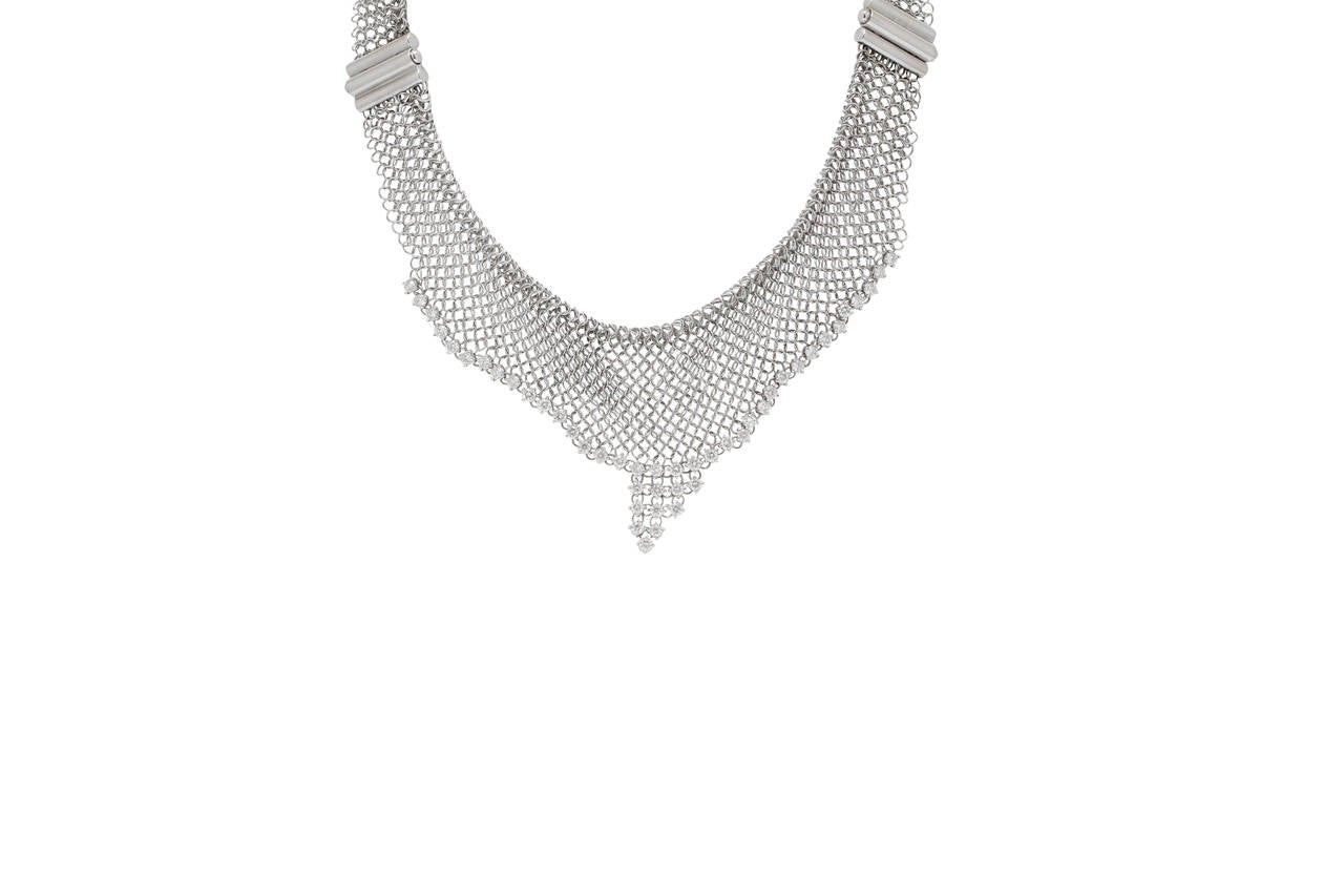 This AMAZING Burdeen's choker-style necklace, is 18K White Gold with white diamonds. The necklace is absolutely sensational...it is flowy, high-fashion, fun to wear, and can be perfect from daytime to evening...jeans to dresses !!!
The necklace has