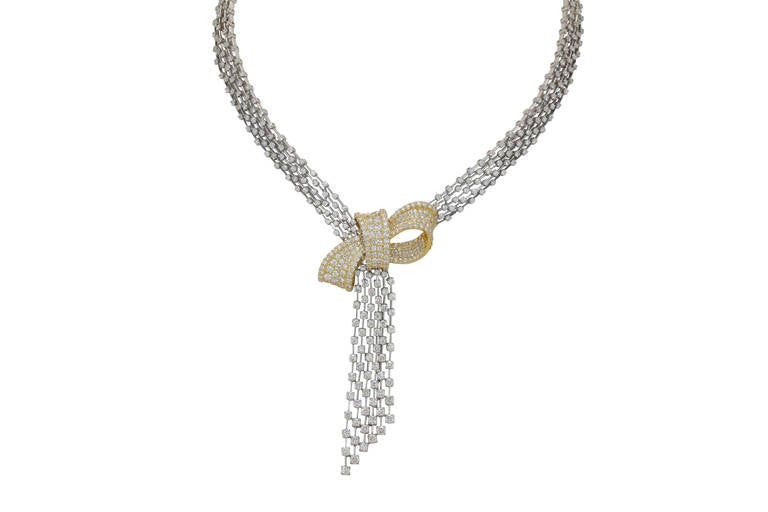 This 18kt gold waterfall style necklace features both white and yellow gold and 14.59 cts of white diamonds of VS clarity and F-G color range.